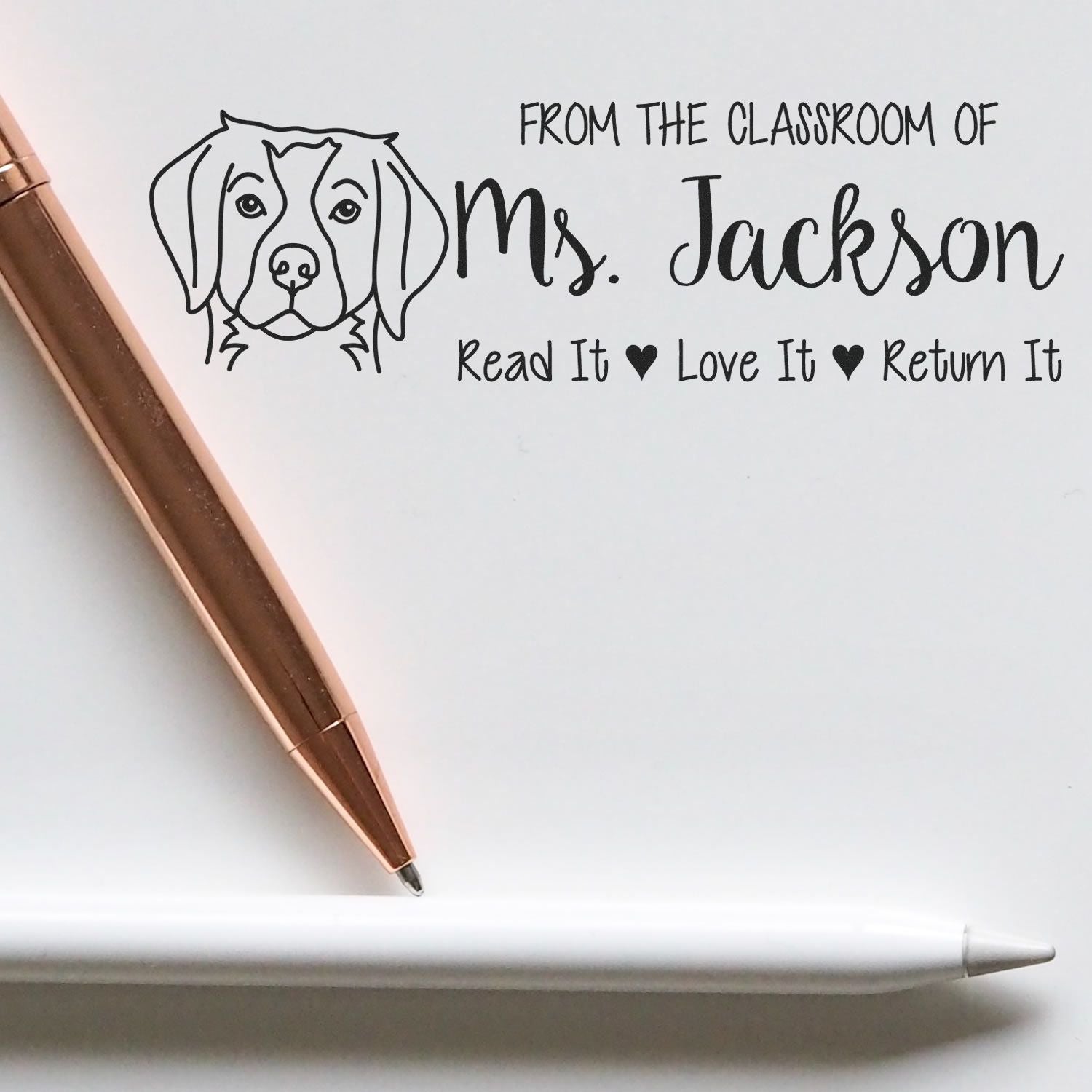 Custom teacher rubber stamp with dog icon and classroom message: From the Classroom of Ms. Jackson, Read It, Love It, Return It.