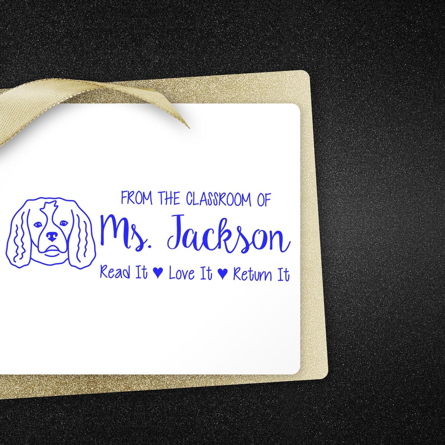 Personalized teacher rubber stamp for classroom books, featuring dog art and Read It Love It Return It for Ms. Jackson