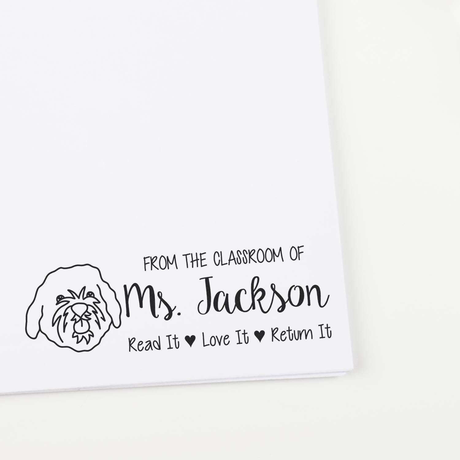 Personalized classroom book rubber stamp for Ms. Jackson with dog icon and Read It Love It Return It message.