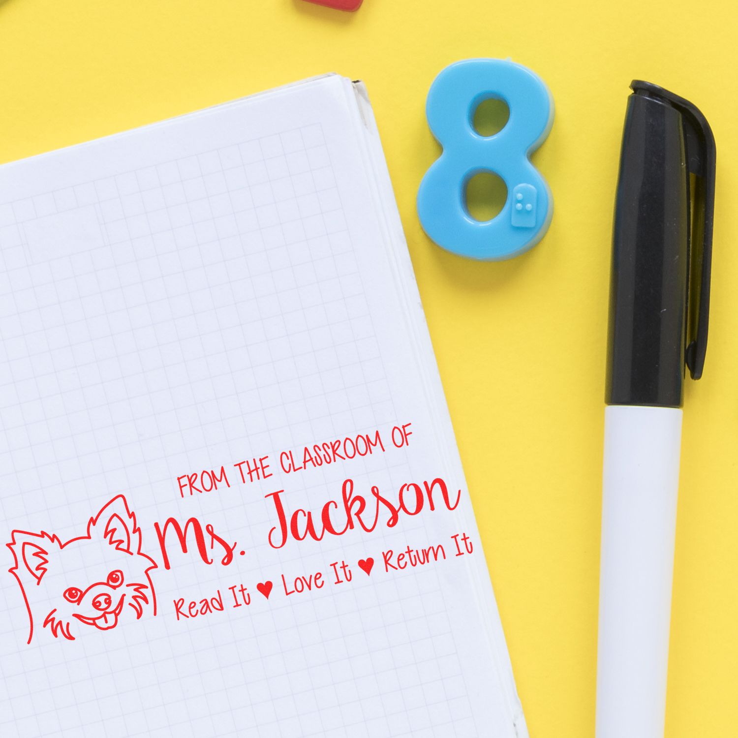 Teacher rubber stamp on notebook: From the Classroom of Ms. Jackson with Read It, Love It, Return It message.