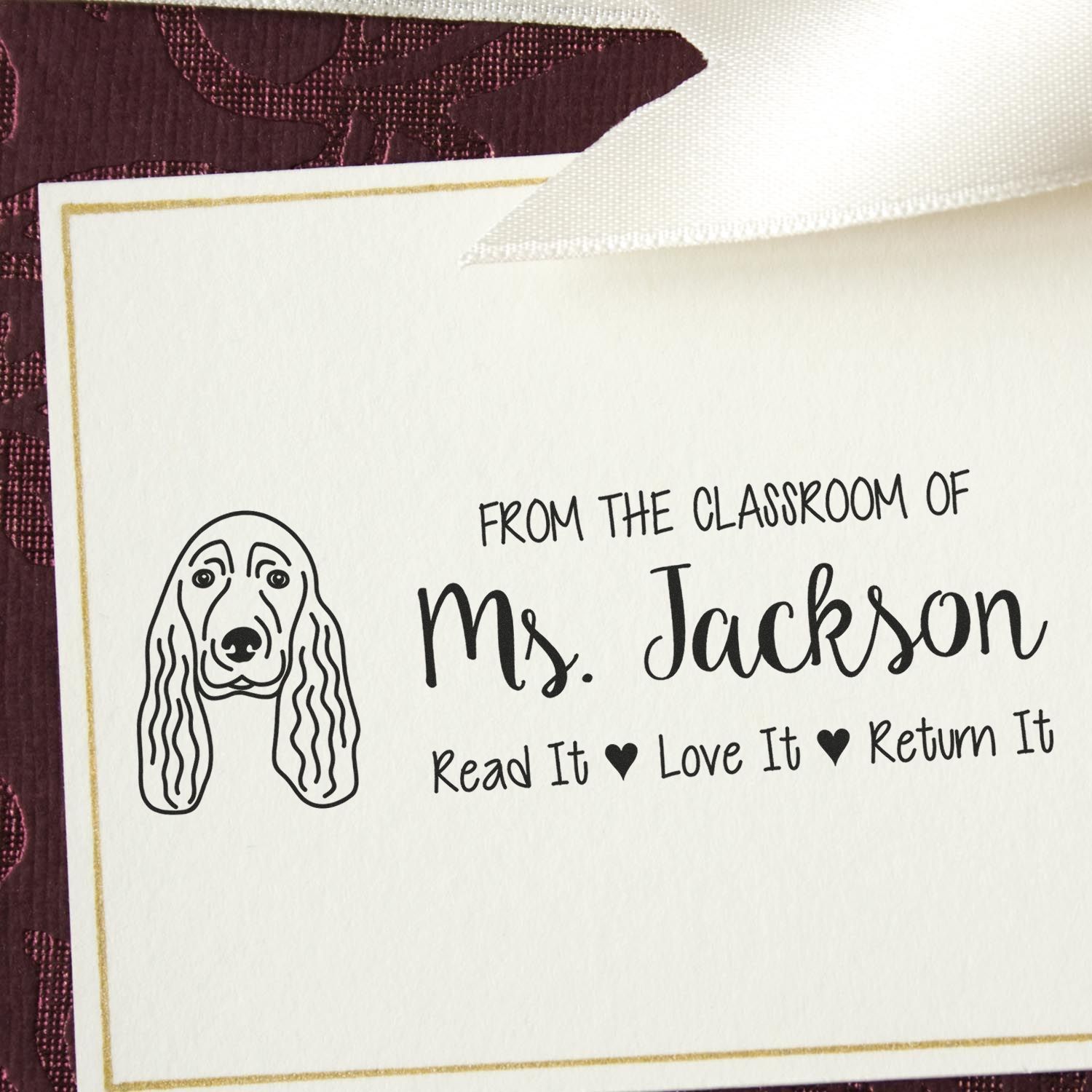 Custom classroom rubber stamp for Ms. Jackson with dog illustration and Read It, Love It, Return It message.