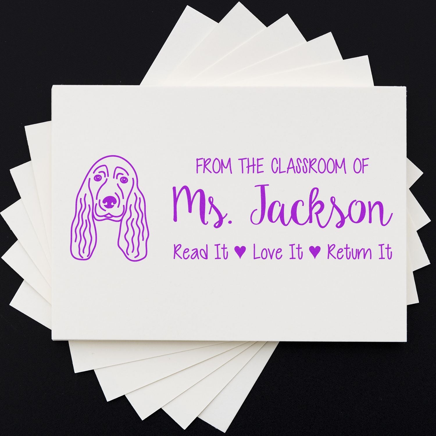 Custom teacher rubber stamp for classroom books, featuring Ms. Jackson and Read It, Love It, Return It with dog design.