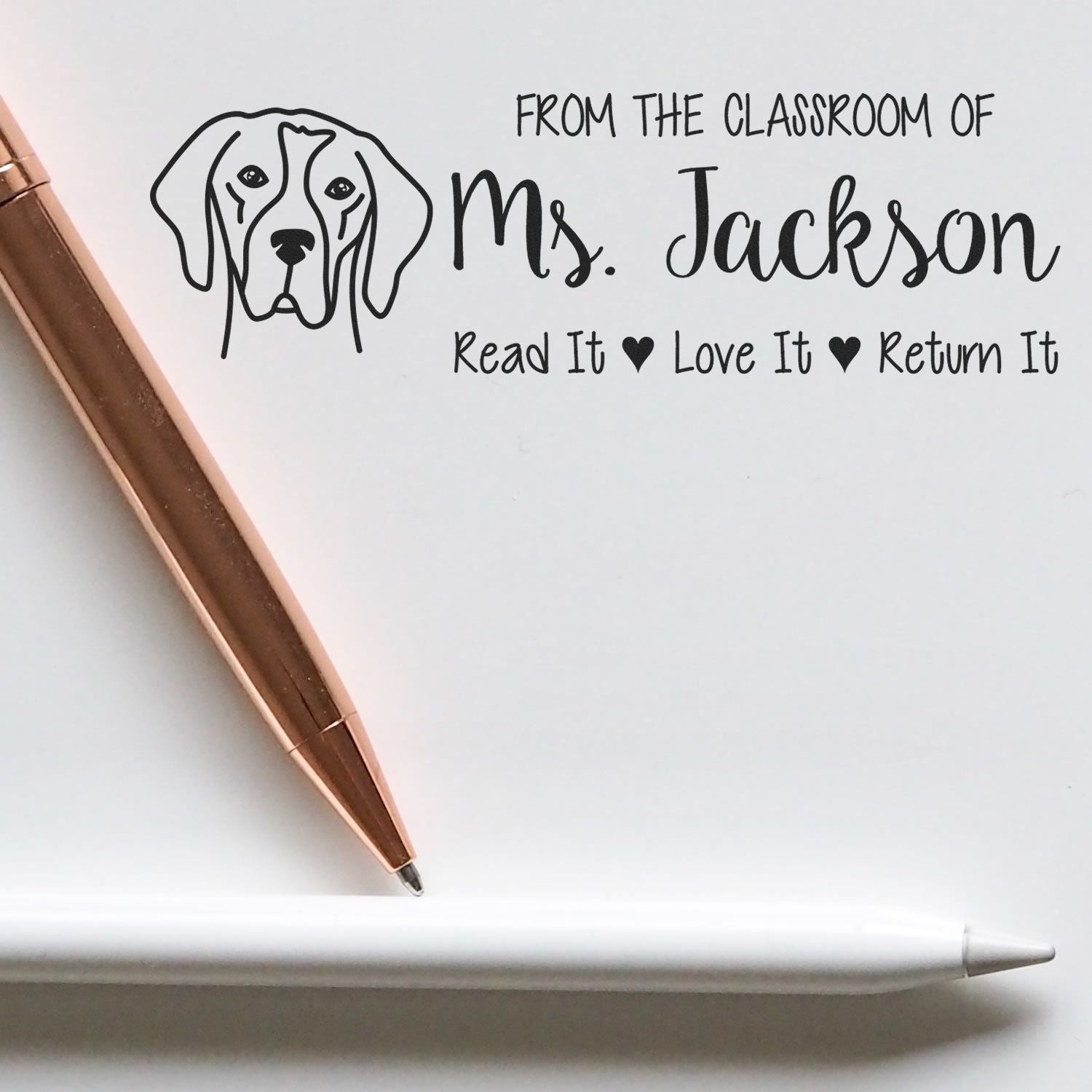 Custom classroom rubber stamp with dog graphic and From the Classroom of Mrs. Jackson  Read It, Love It, Return It teacher message.