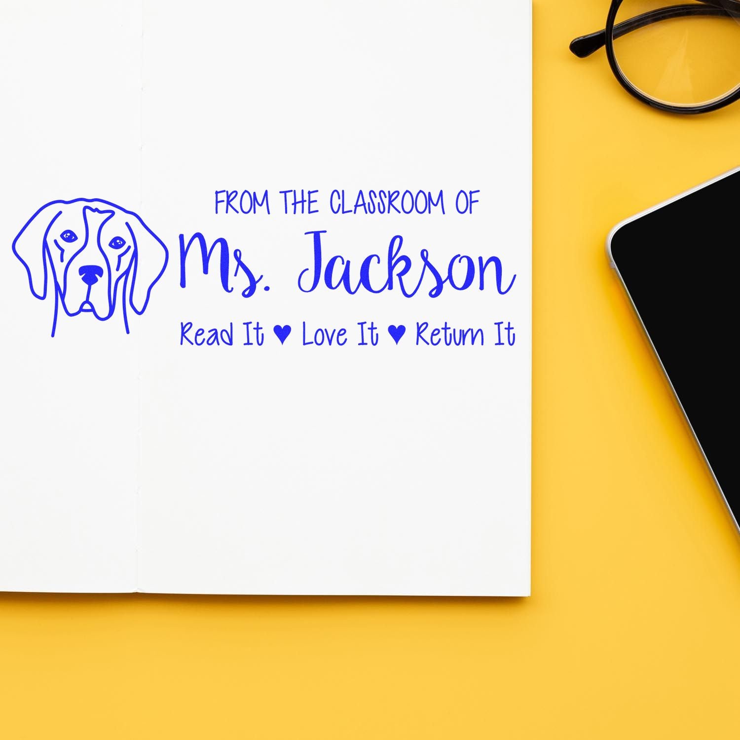 Custom classroom rubber stamp for Ms. Jackson, featuring a dog icon and Read It, Love It, Return It book label.