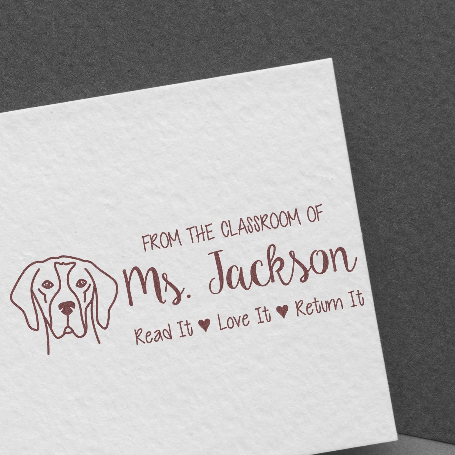 Personalized classroom rubber stamp for Ms. Jackson with dog icon and Read It, Love It, Return It book label.