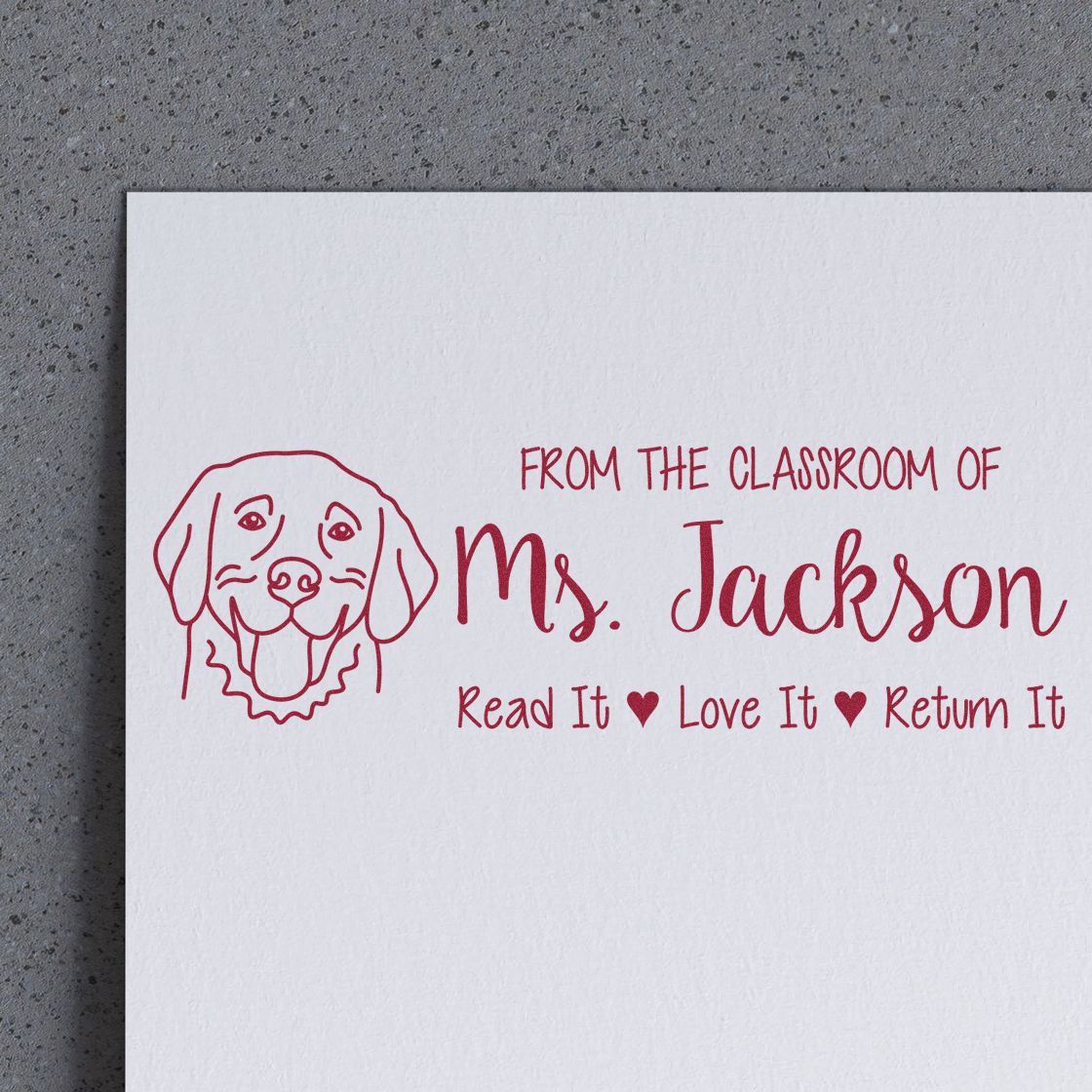 Custom teacher rubber stamp with dog illustration and text: From the classroom of Ms. Jackson, Read it, Love it, Return it.