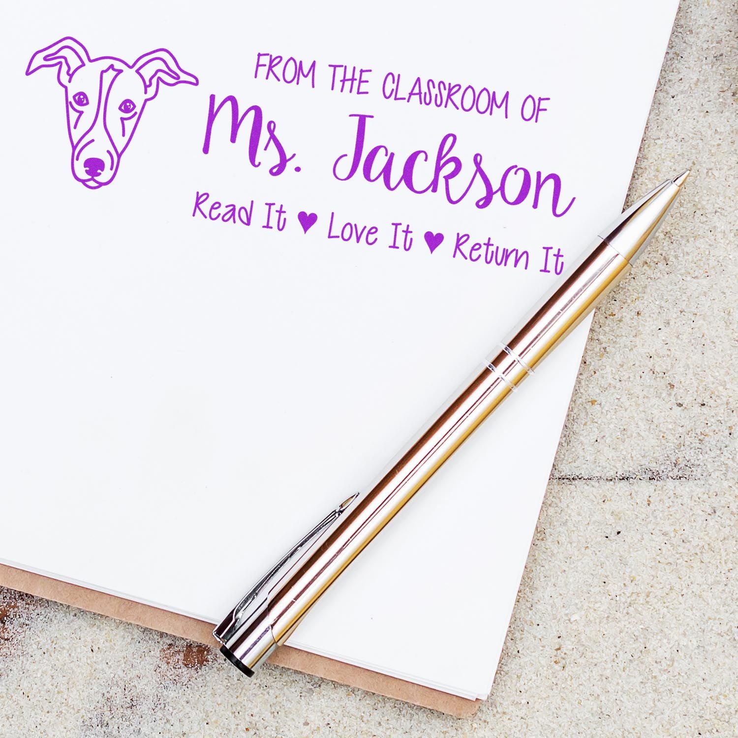 Personalized teacher rubber stamp with dog icon and From the classroom of Ms. Jackson, Read It Love It Return It message.