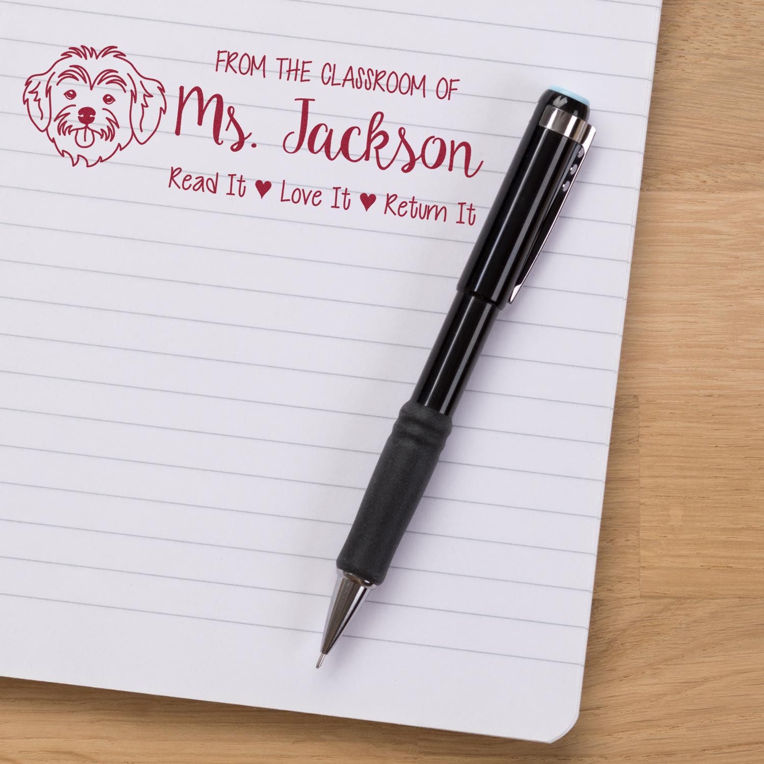 Custom teacher rubber stamp with dog design and Read It, Love It, Return It classroom library message for Ms. Jackson.