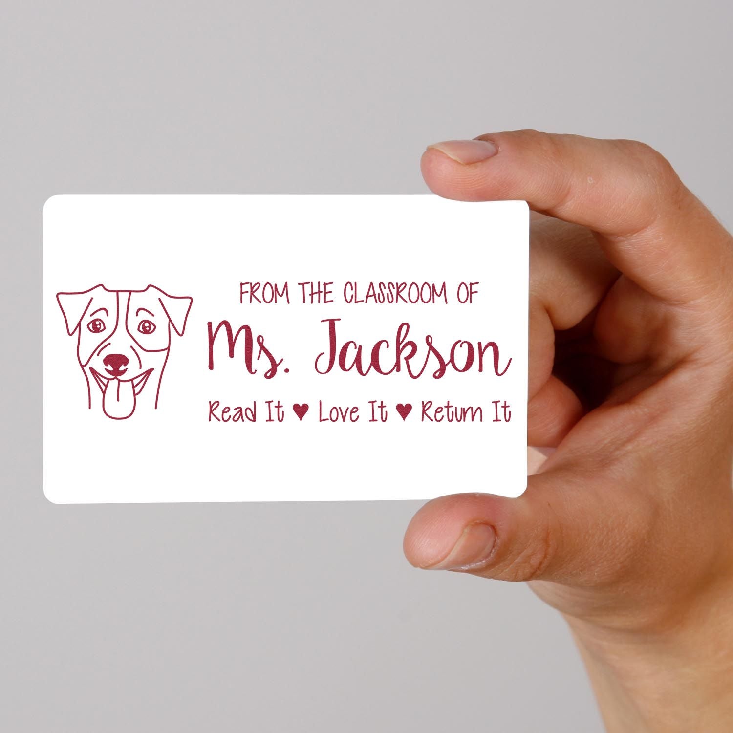 Personalized teacher rubber stamp with dog design and Read It, Love It, Return It classroom library label for Ms. Jackson.
