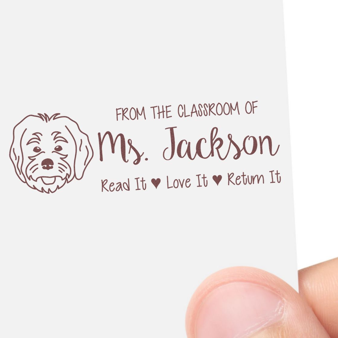 Custom teacher rubber stamp for book labels: From the classroom of Ms. Jackson, Read It Love It Return It with dog icon.