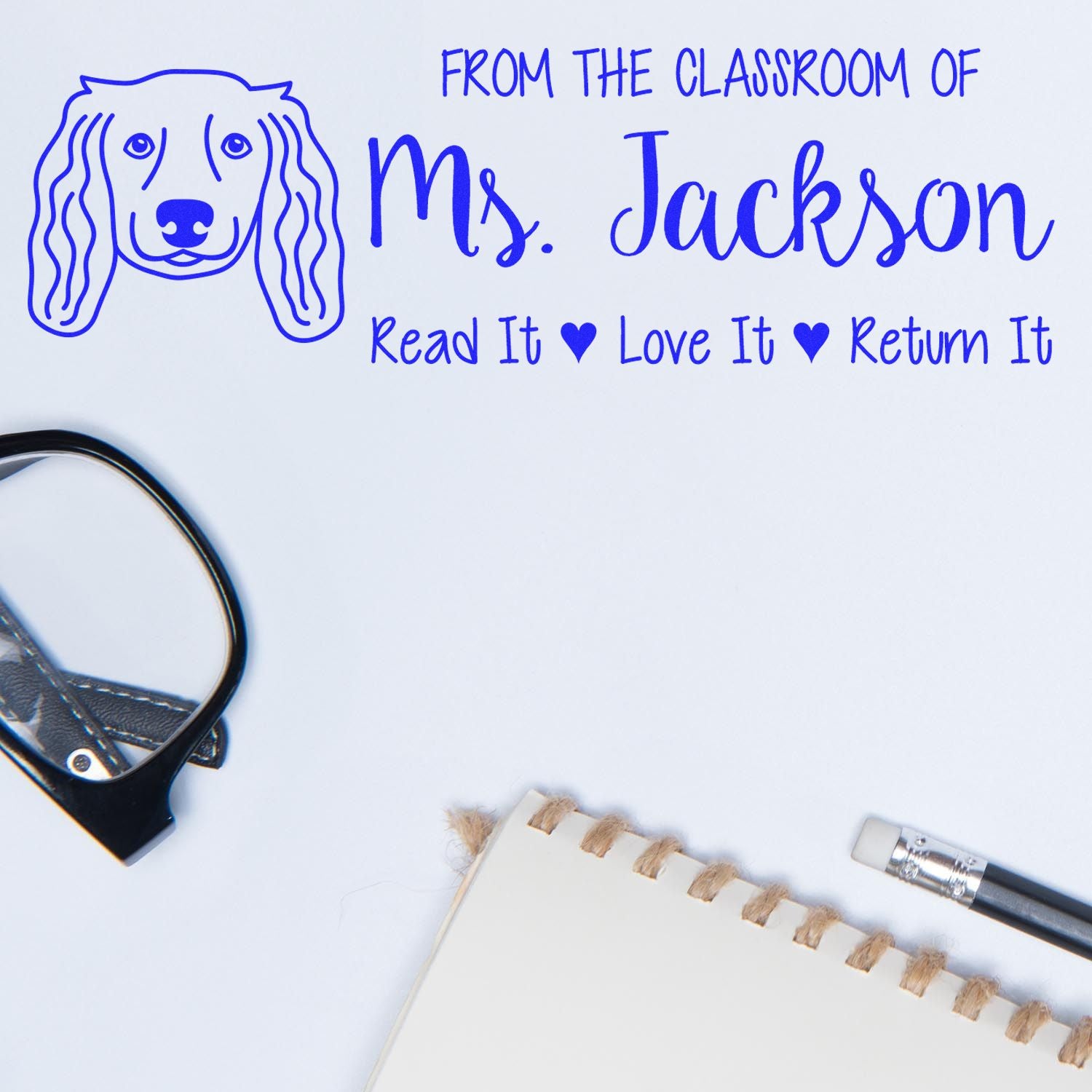 Custom classroom rubber stamp with dog illustration and bookplate text: From the Classroom of Ms. Jackson, Read It Love It Return It.