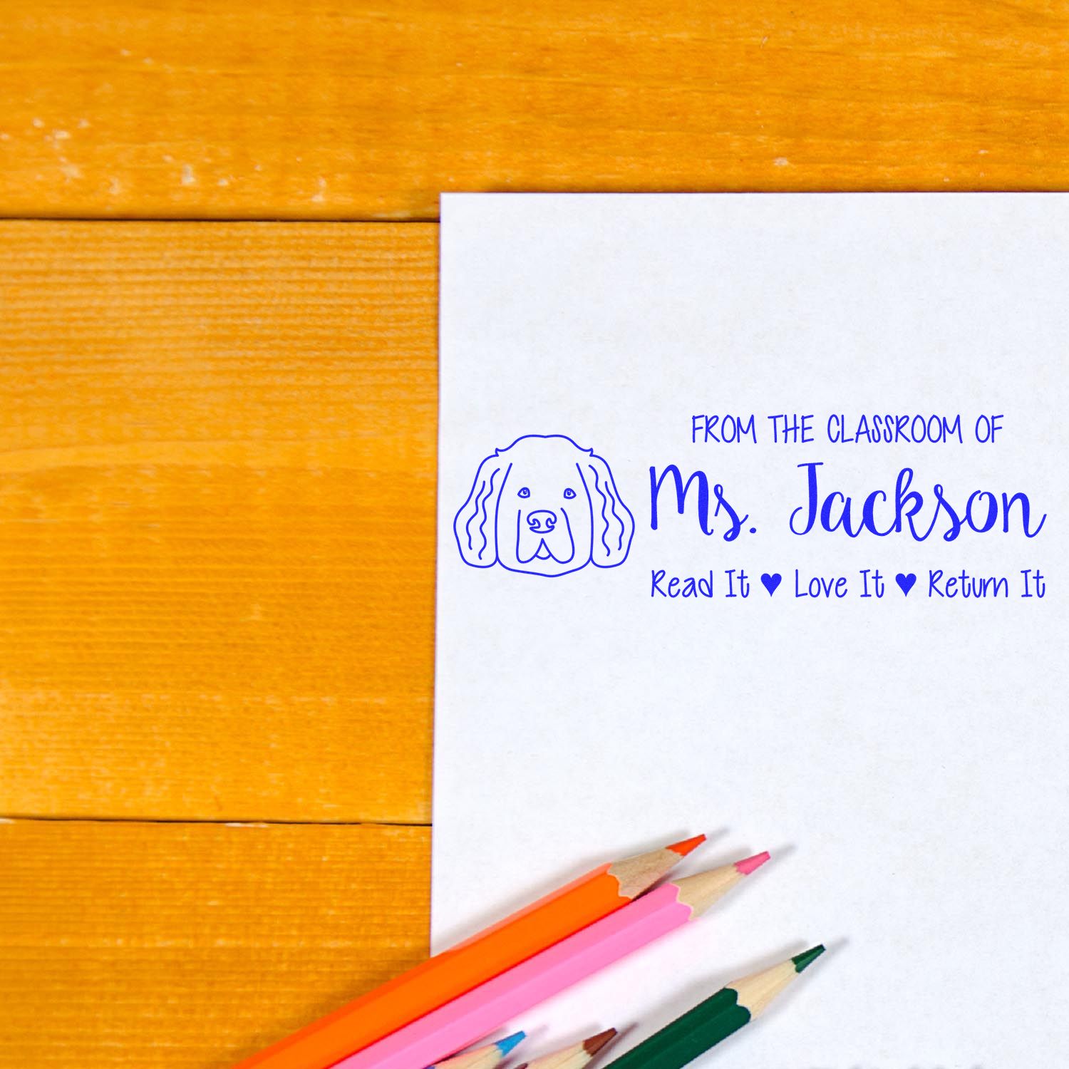 Personalized teacher rubber stamp for Mrs. Jackson with dog icon and Read It, Love It, Return It classroom book label