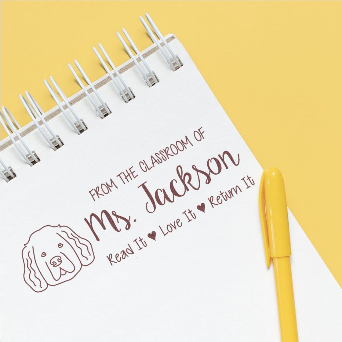 Personalized teacher library rubber stamp for Mrs. Jackson, with dog icon and Read It, Love It, Return It message.