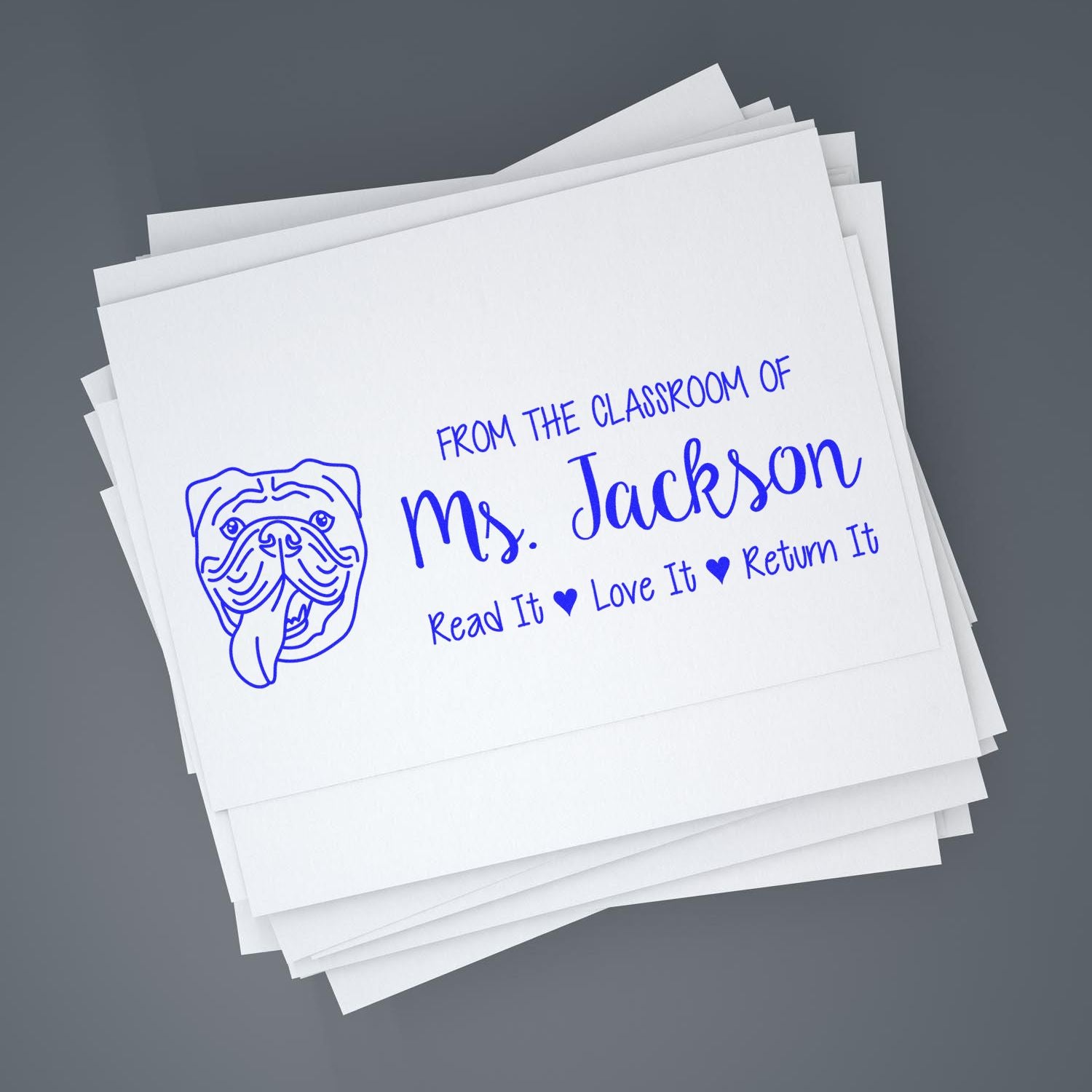 Custom teacher rubber stamp for Ms. Jackson with bulldog design and Read It, Love It, Return It classroom book label.