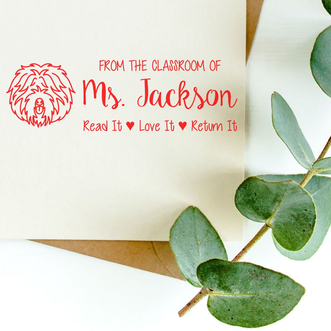 Custom classroom rubber stamp for books, featuring dog icon and From the Classroom of Ms. Jackson, Read It Love It Return It.