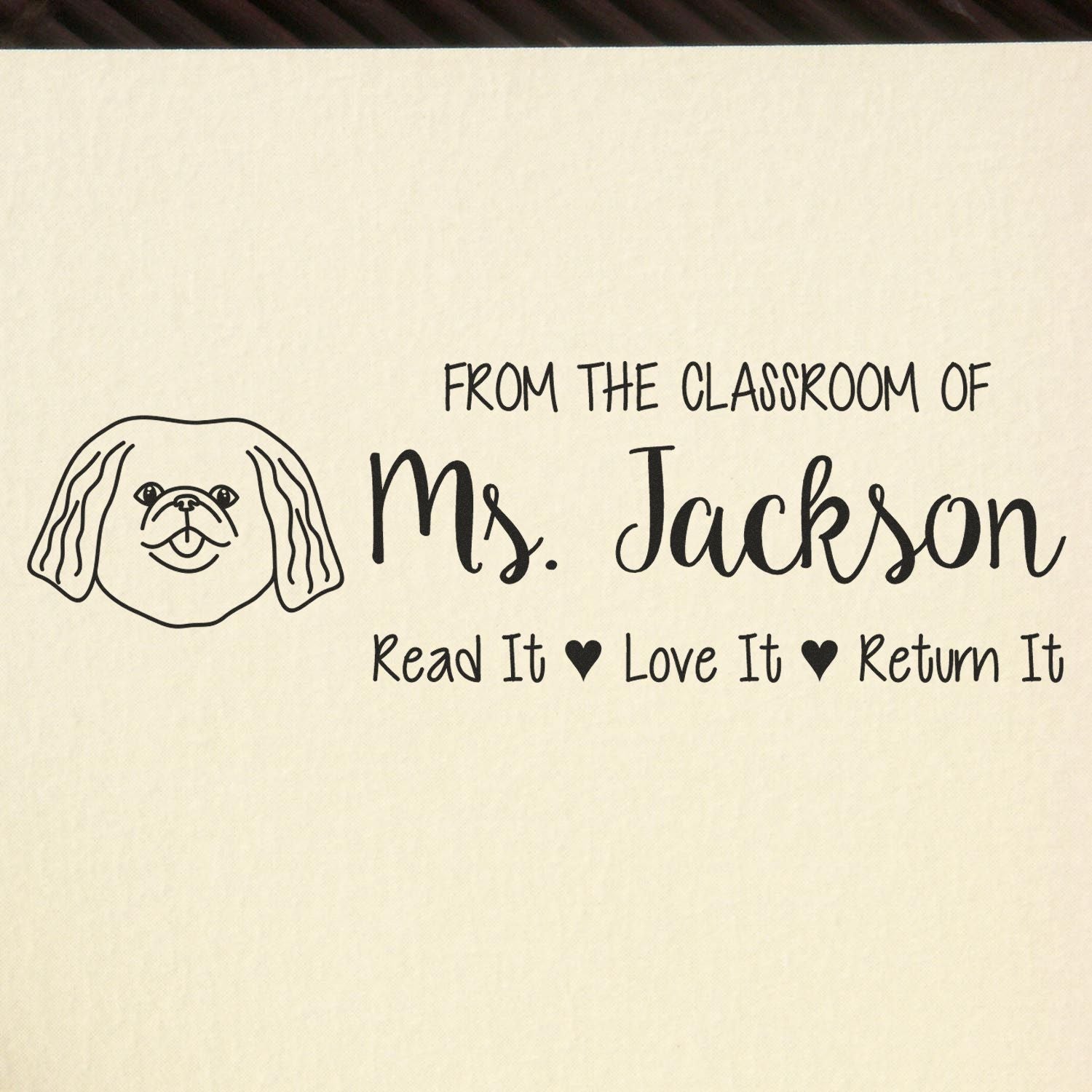 Personalized teacher rubber stamp with dog design and Read It Love It Return It classroom book message for Ms. Jackson.