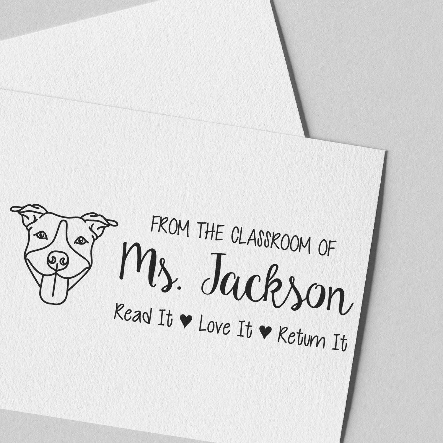 Personalized teacher rubber stamp with dog logo for Ms. Jackson, reading Read It, Love It, Return It classroom book stamp.