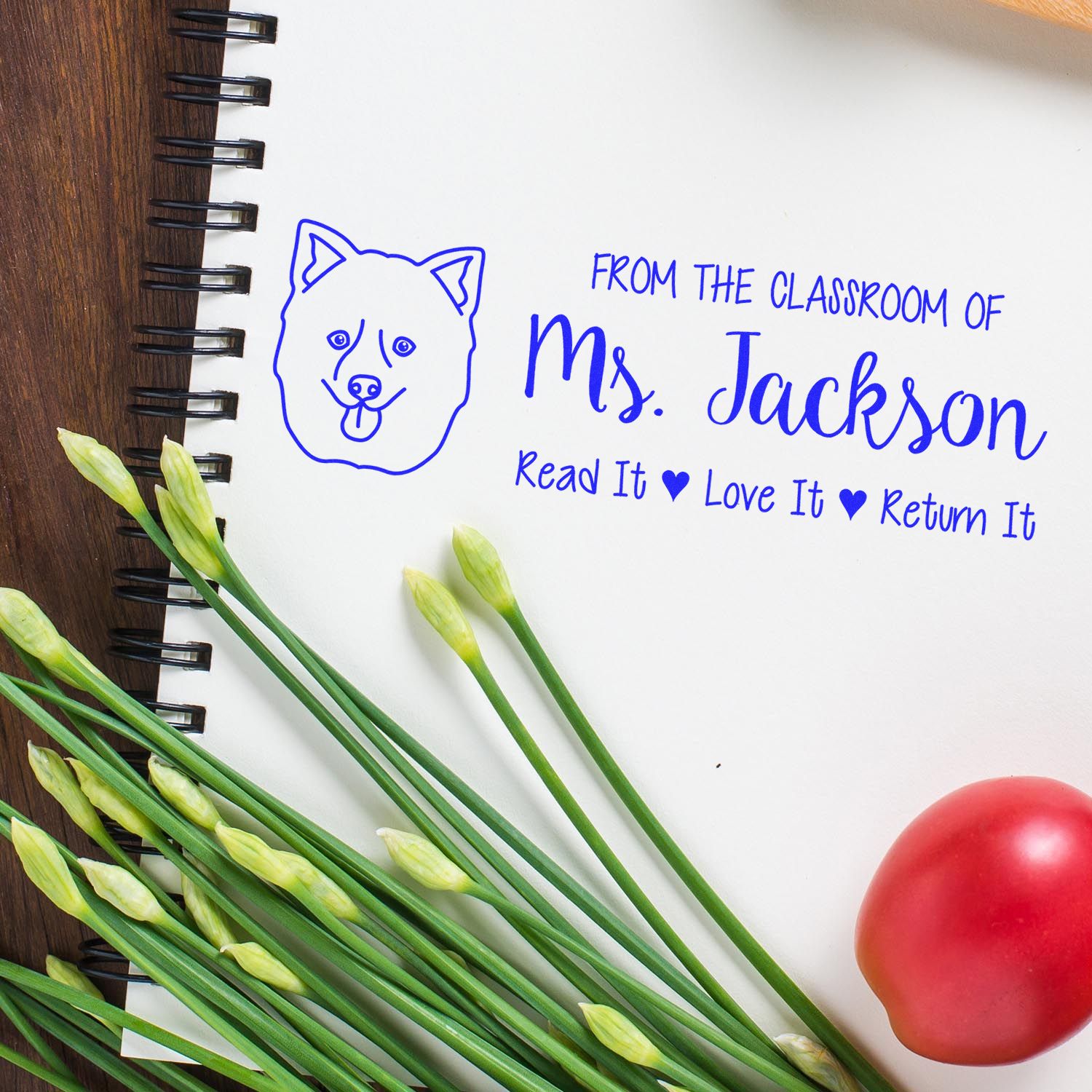 Personalized teacher rubber stamp with dog icon and return reminder text on notebook, From the Classroom of Ms. Jackson.