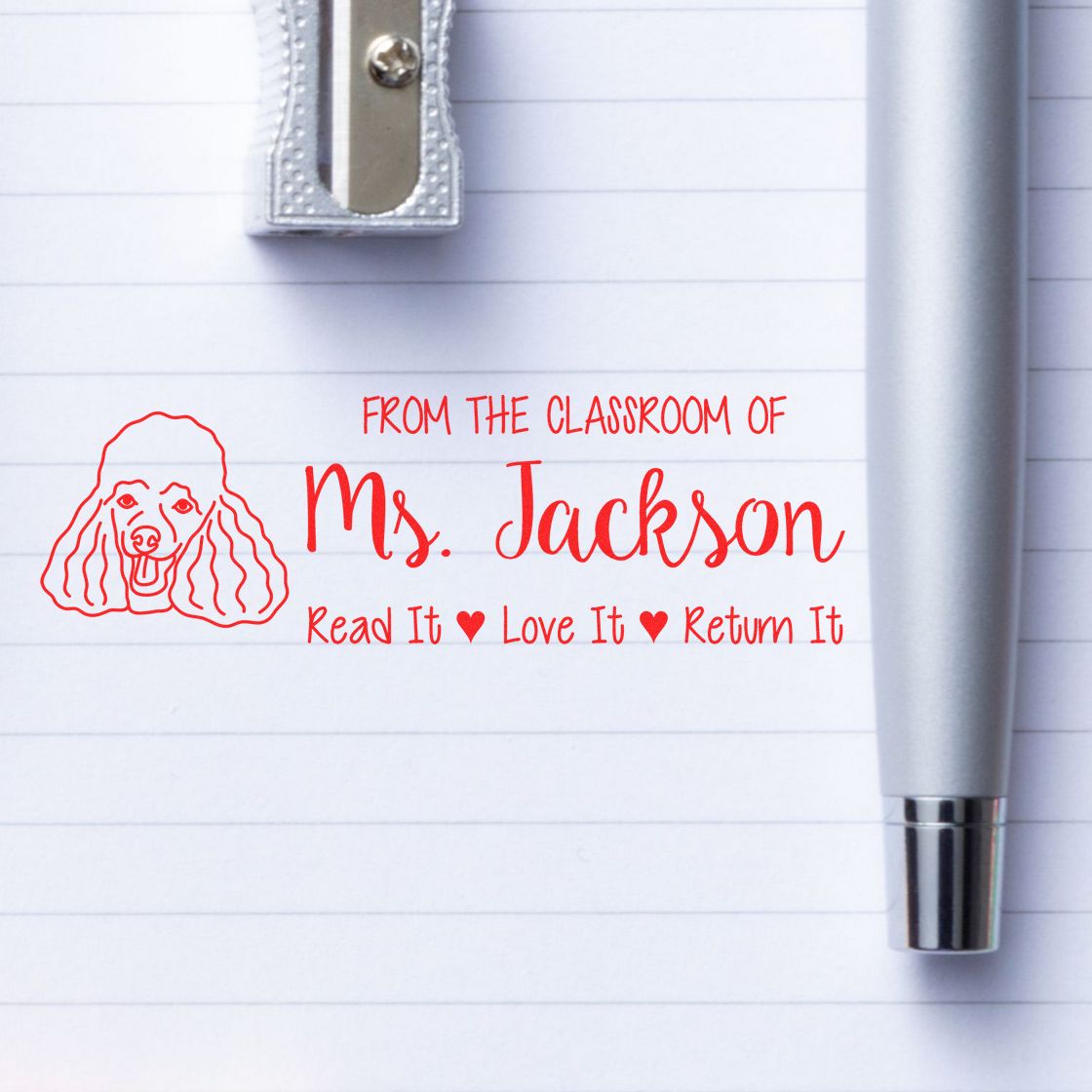 Personalized teacher rubber stamp for Ms. Jackson with dog icon and Read It, Love It, Return It classroom book label.