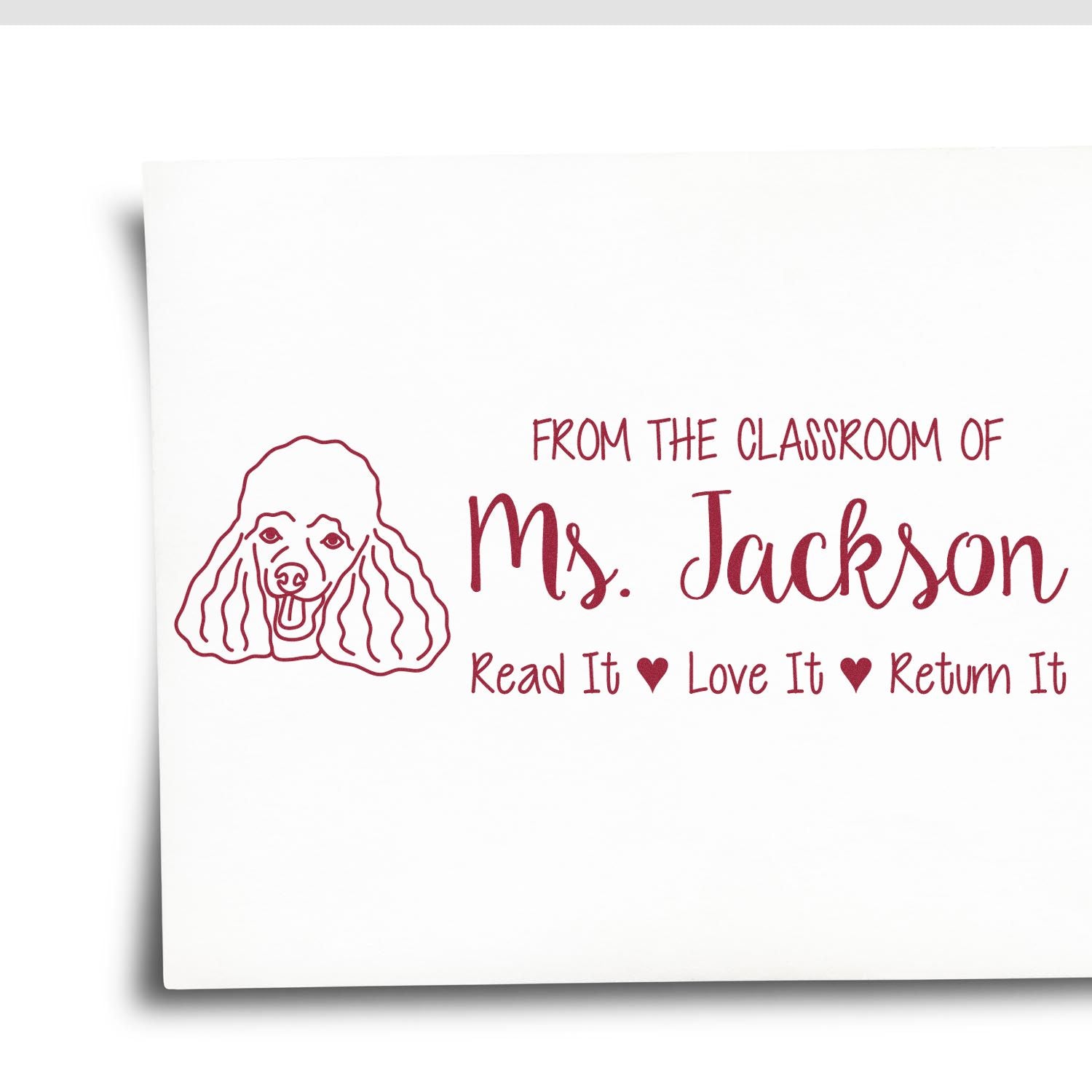 Custom teacher rubber stamp with poodle illustration, from the classroom of Ms. Jackson, Read It, Love It, Return It.