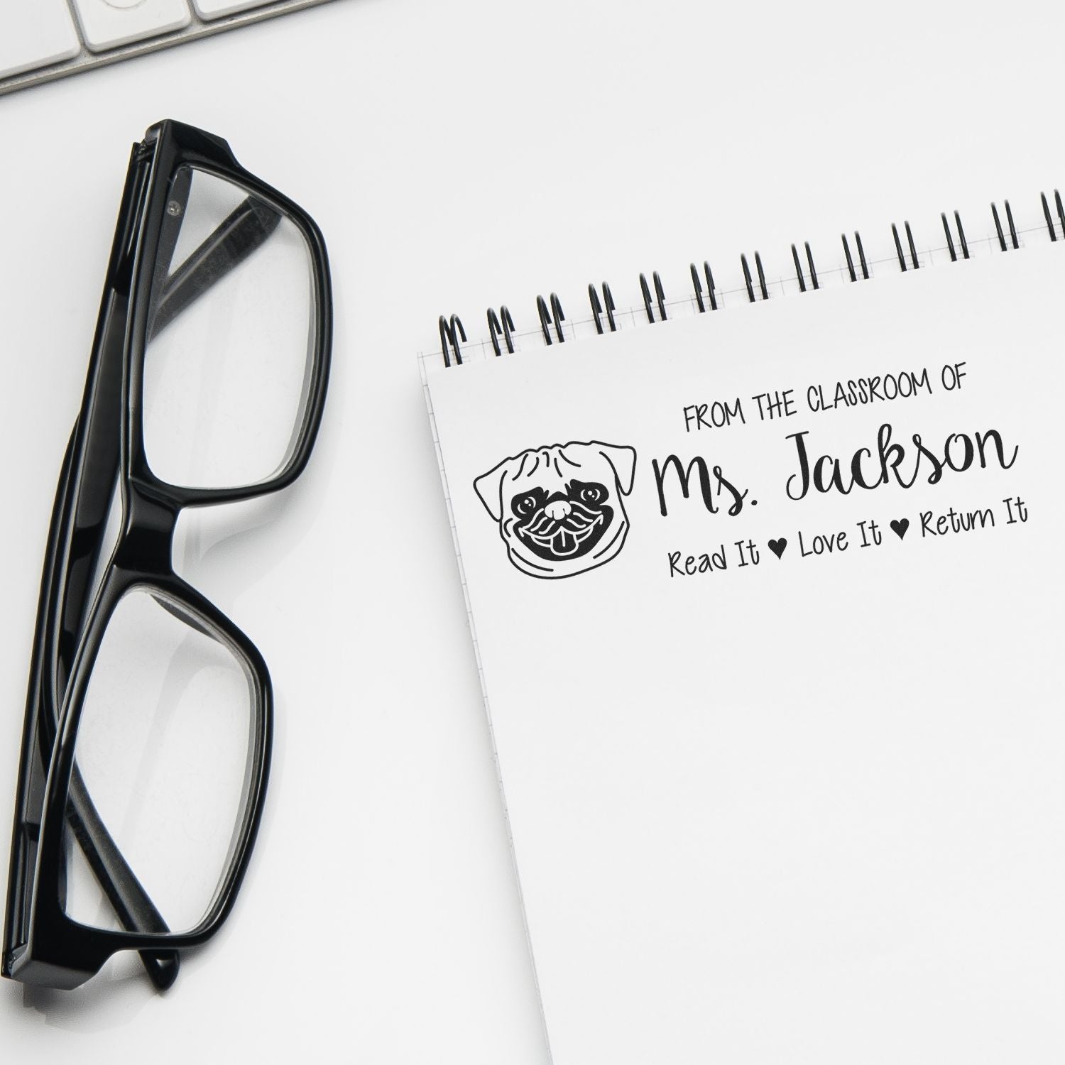 Teacher rubber stamp for classroom books, personalized for Mrs. Jackson with pug logo and Read It, Love It, Return It.