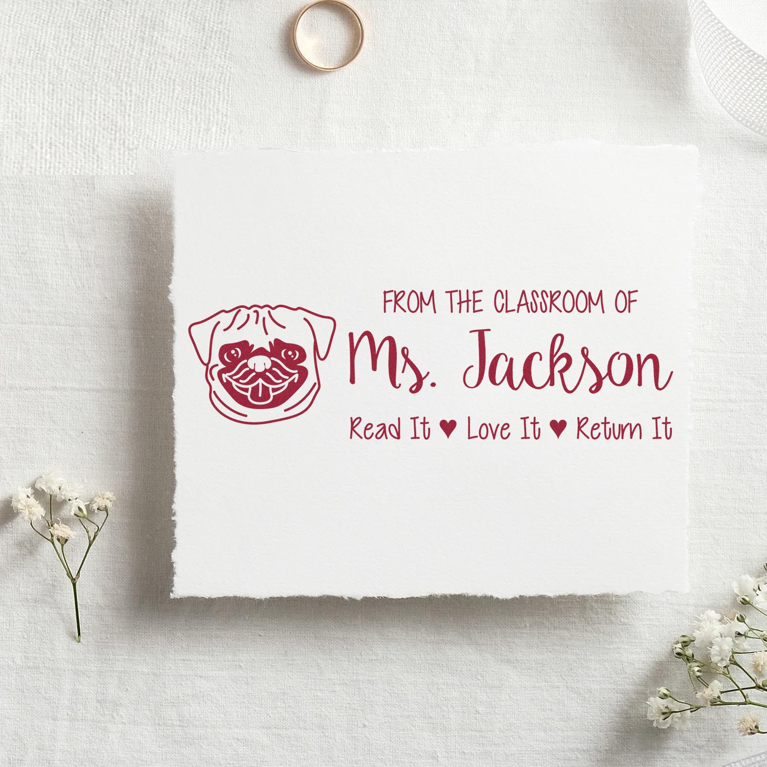 Personalized teacher rubber stamp for Ms. Jacksons classroom library books, with pug design and Read It Love It Return It.