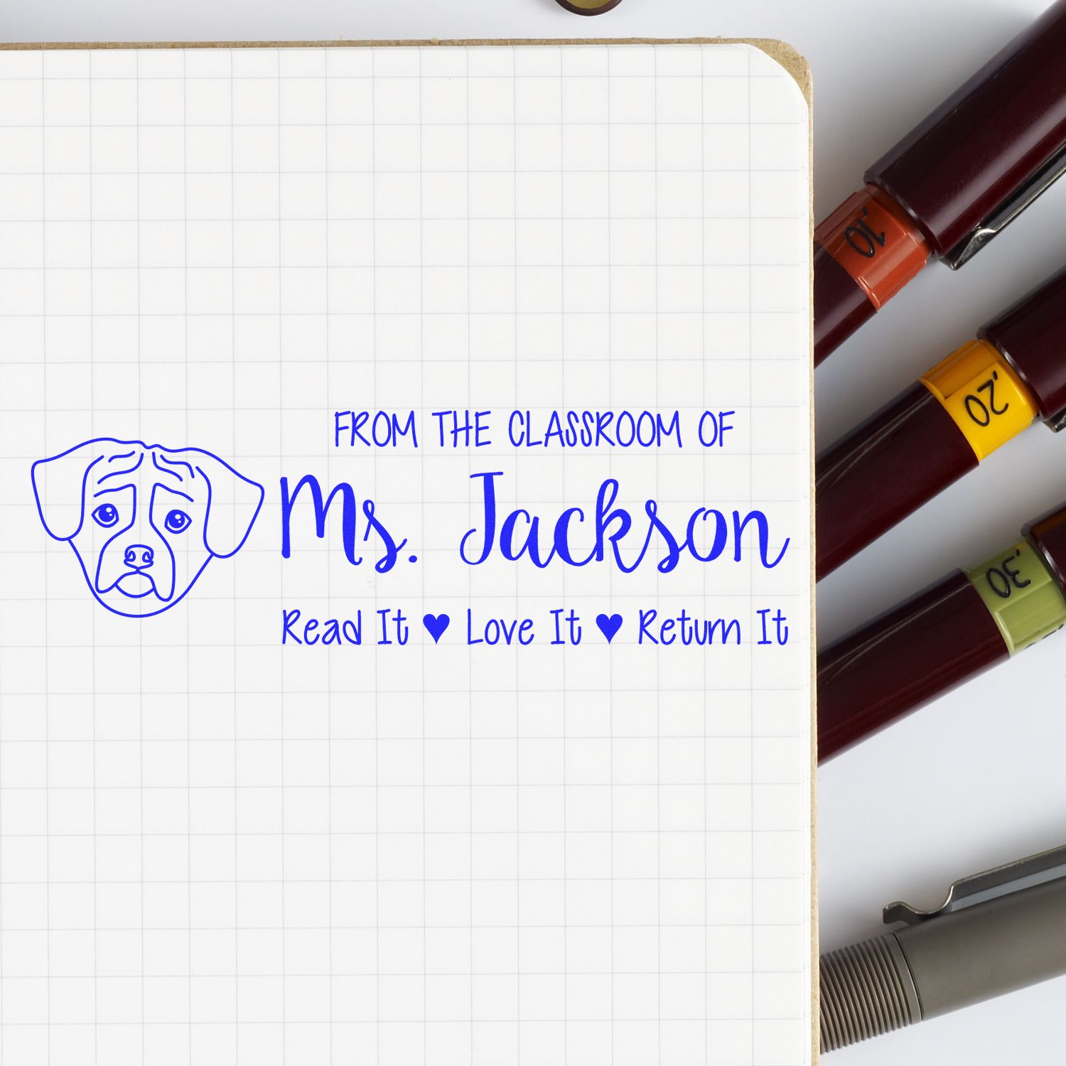 Custom teacher rubber stamp for Ms. Jackson with dog icon and book-return message: Read It, Love It, Return It.