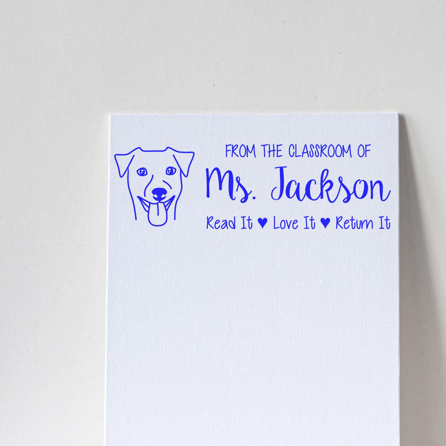 Personalized classroom rubber stamp for Ms. Jackson with dog icon and Read It, Love It, Return It book message.