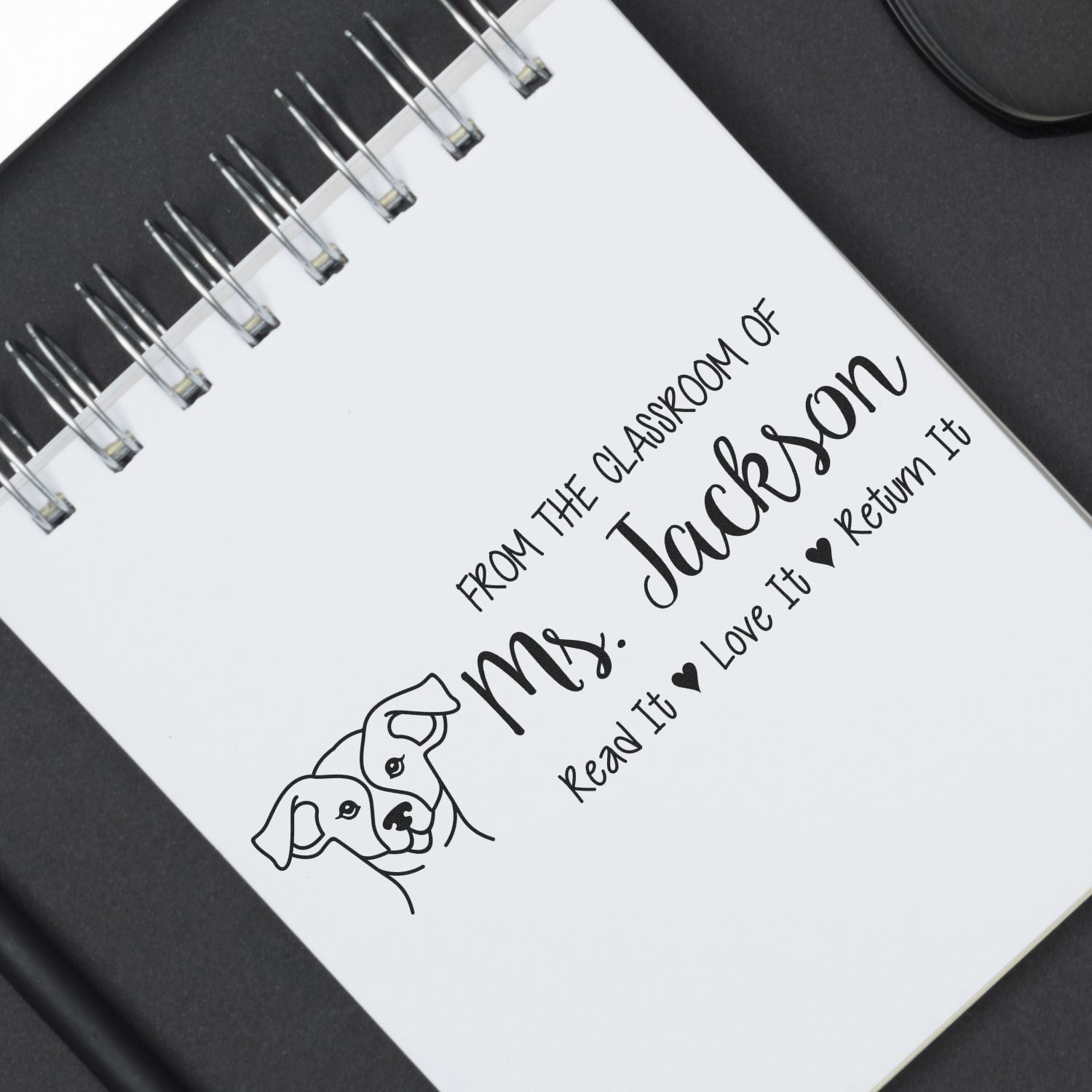 Custom teacher rubber stamp with dog illustration, featuring From the classroom of Mrs. Jackson book return message.