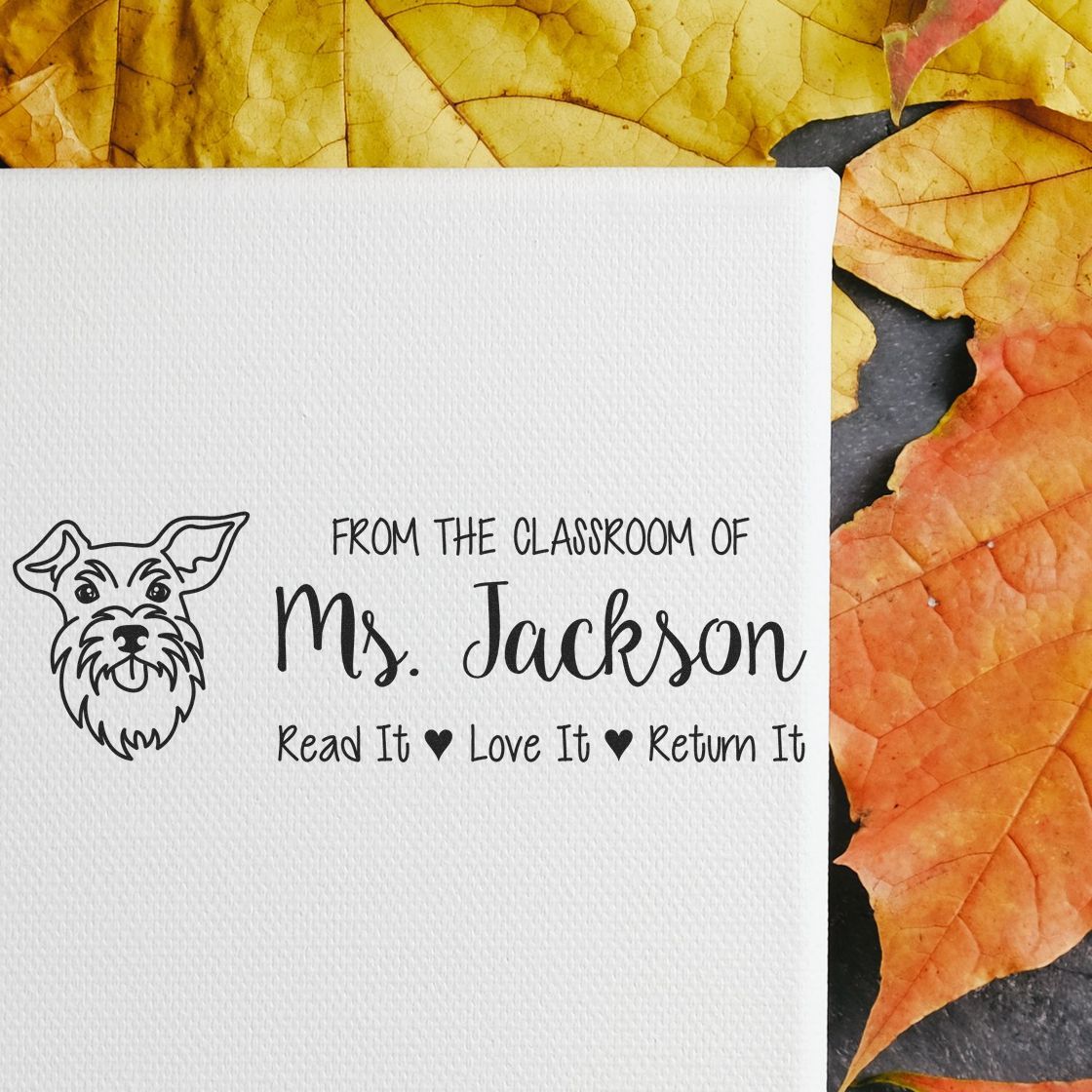 Custom teacher rubber stamp with dog icon and From the Classroom of Ms. Jackson, Read It Love It Return It library book label.