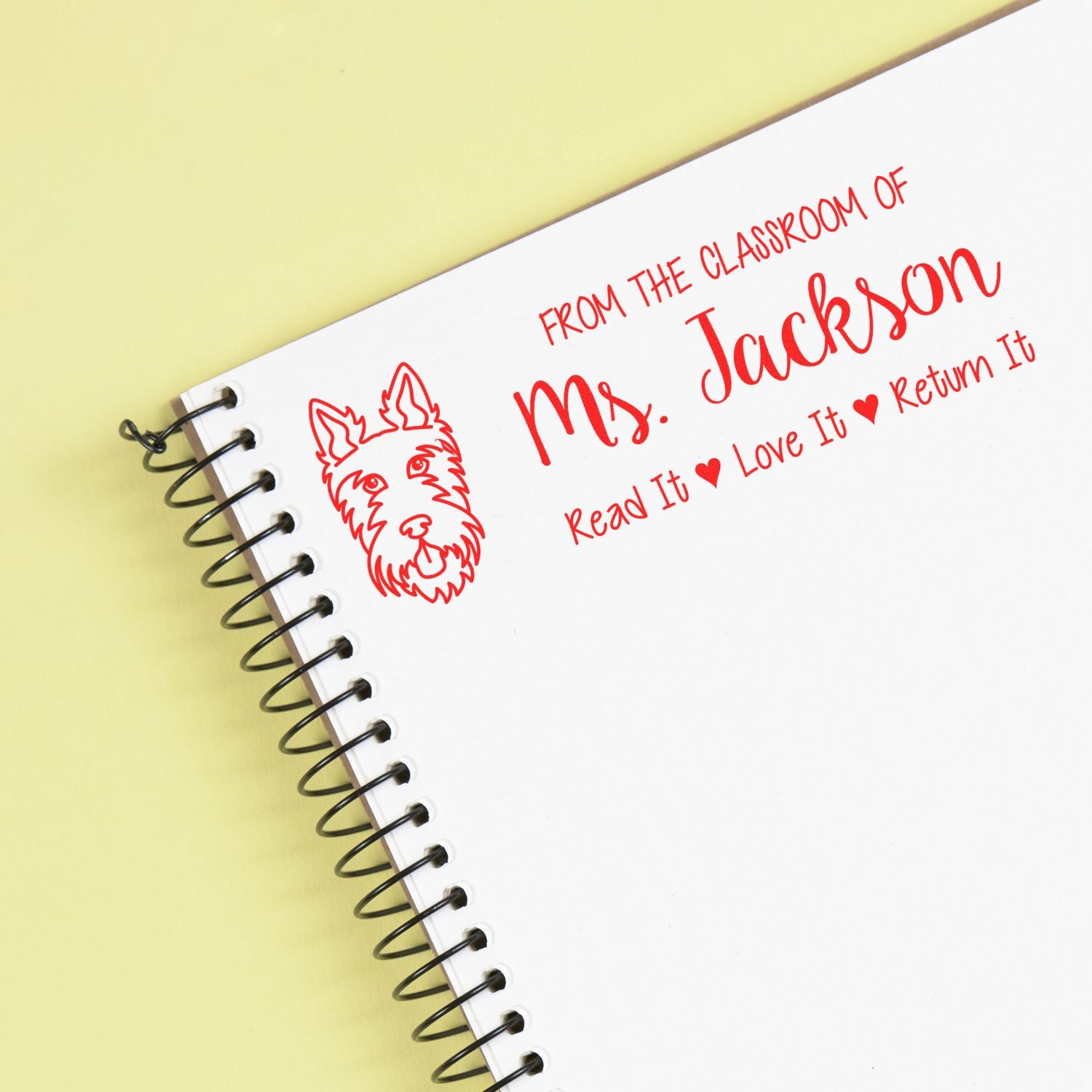 Custom teacher rubber stamp for books and notebooks, featuring Ms. Jackson, a dog graphic, and Read It, Love It, Return It.