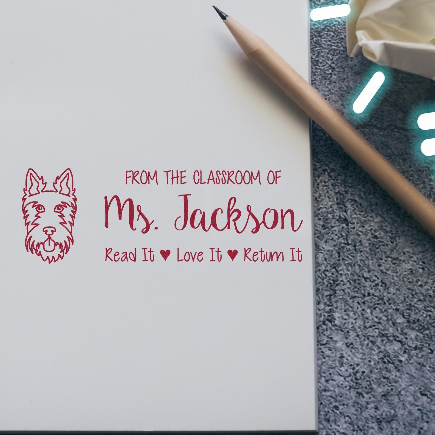 Personalized teacher rubber stamp for classroom books: From the classroom of Ms. Jackson, Read it, Love it, Return it with dog icon.