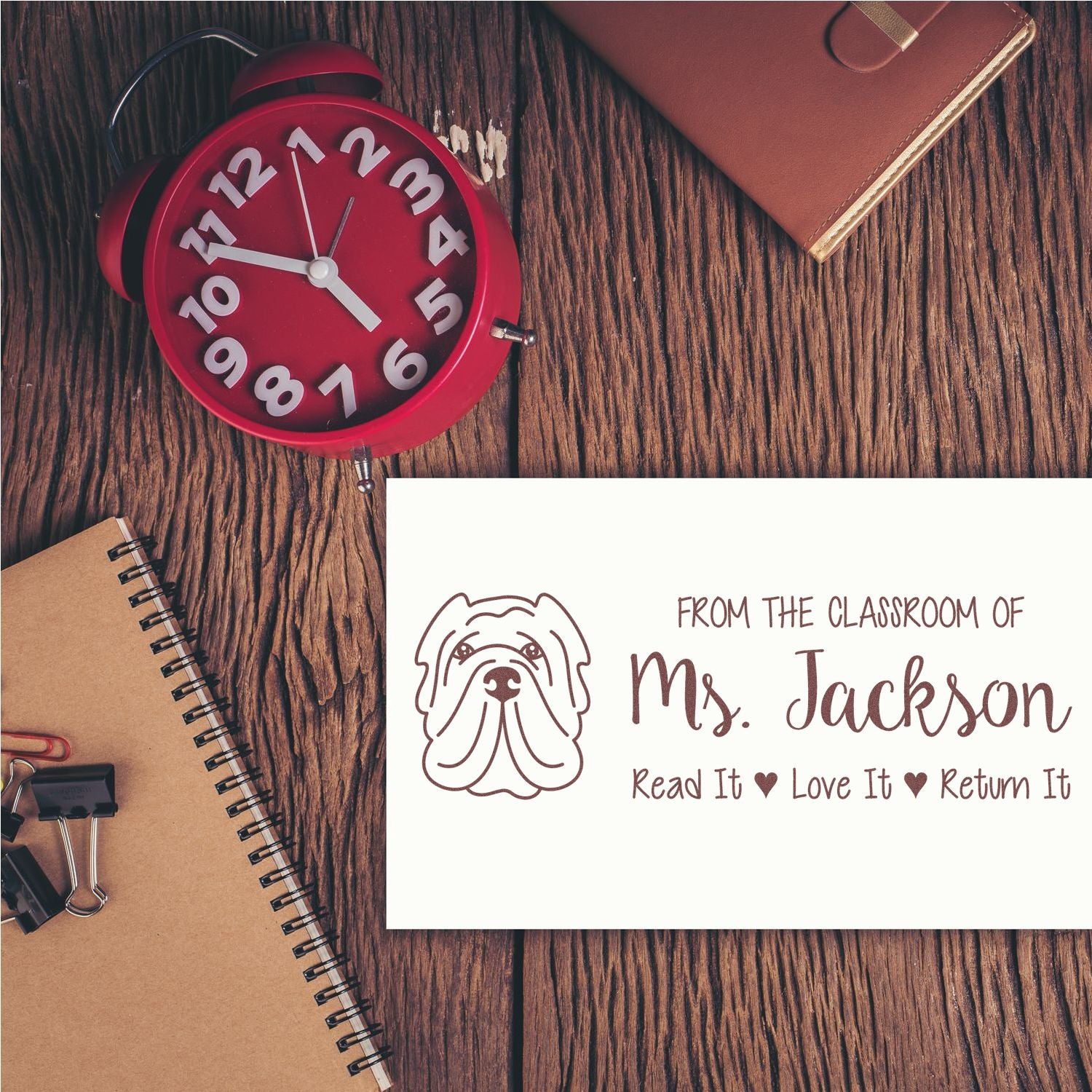 Custom teacher rubber stamp for Ms. Jackson, featuring a dog logo and Read It, Love It, Return It classroom book label.