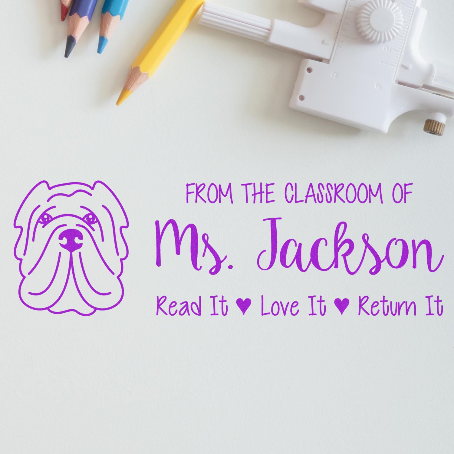 Custom teacher rubber stamp for Ms. Jackson with dog logo and Read It Love It Return It classroom message.