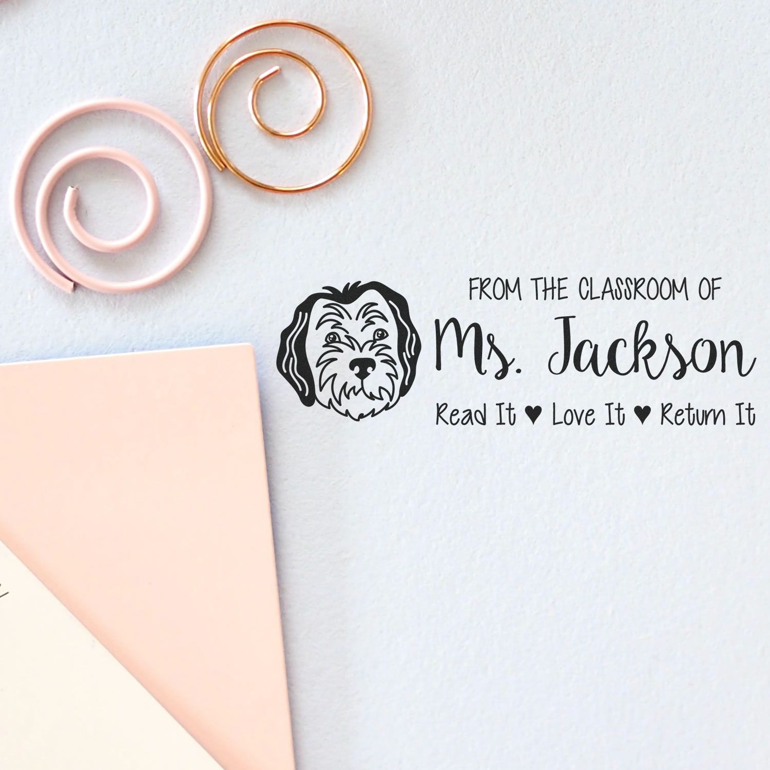 Custom classroom library rubber stamp for Ms. Jackson, with dog design and Read It Love It Return It book return message.