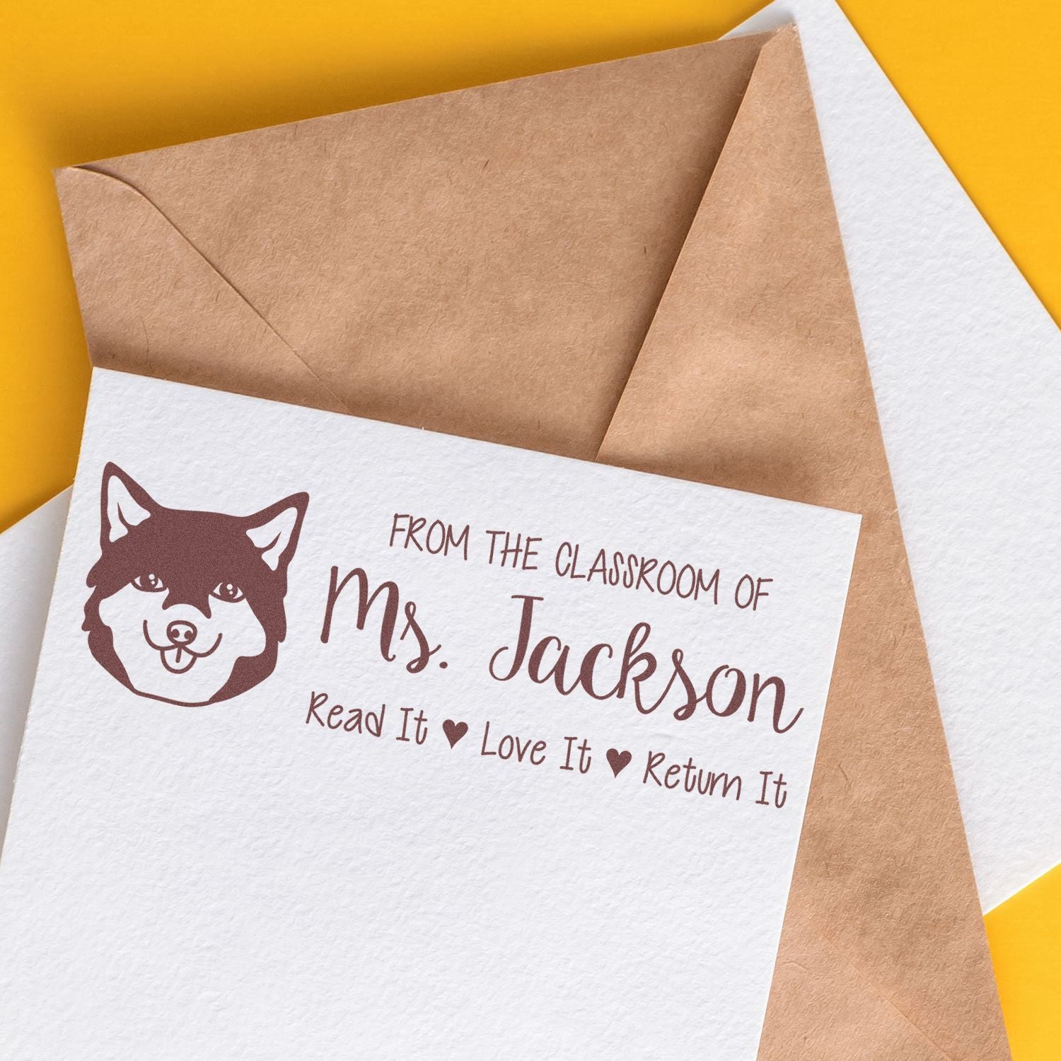 Personalized teacher rubber stamp with husky icon and classroom book return message for Ms. Jackson.
