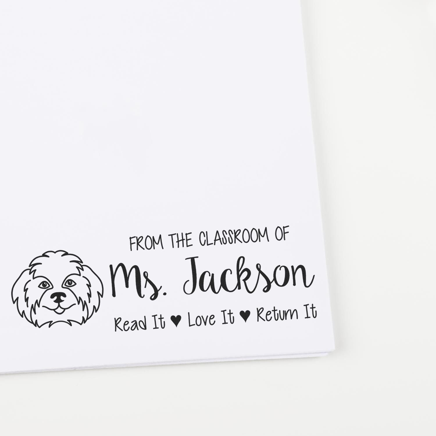 Custom teacher book rubber stamp for Mrs. Jackson with dog illustration and Read It, Love It, Return It message.
