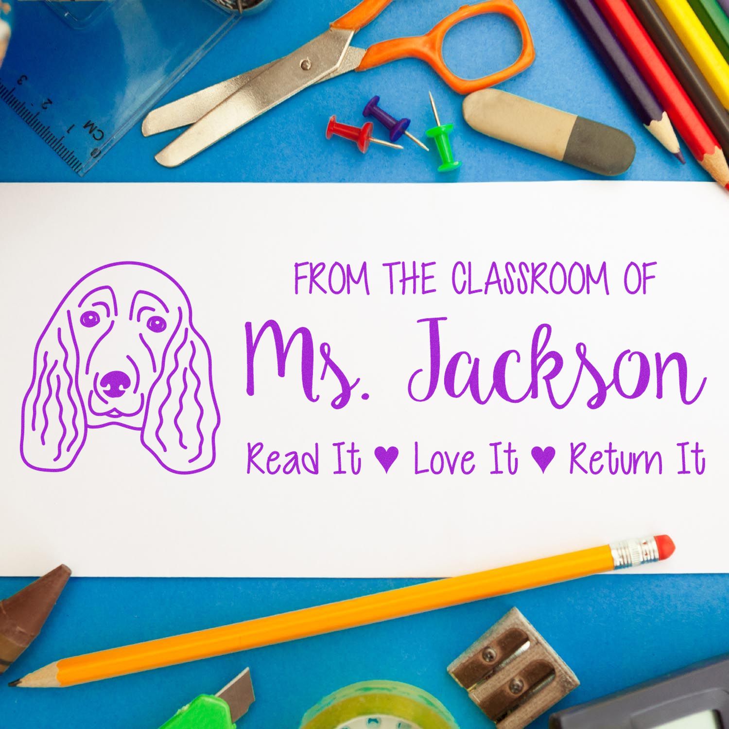 Personalized classroom rubber stamp with dog design and Read It Love It Return It book label for Ms. Jackson.