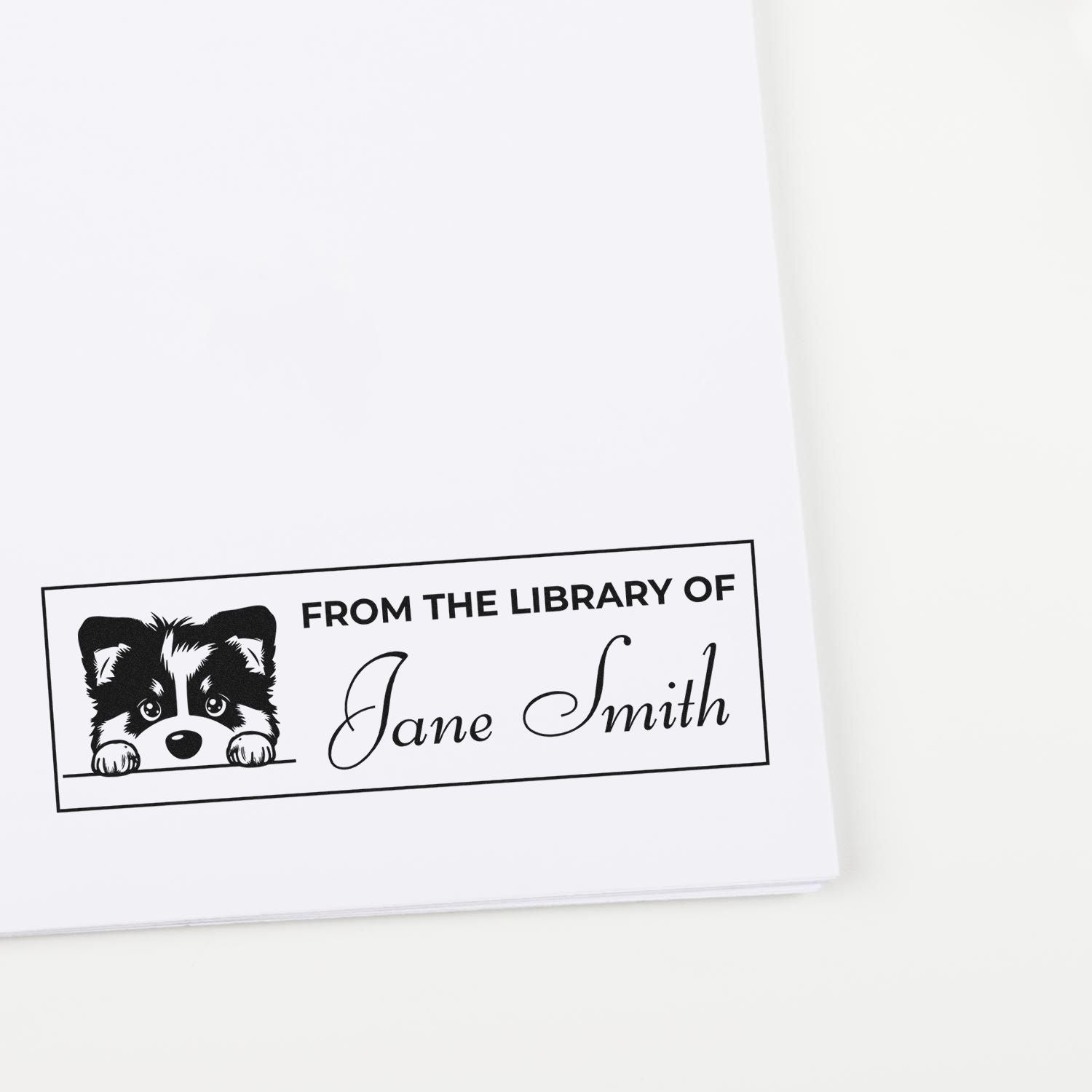 Personalized rubber library stamp with dog illustration and name Jane Smith for marking books.