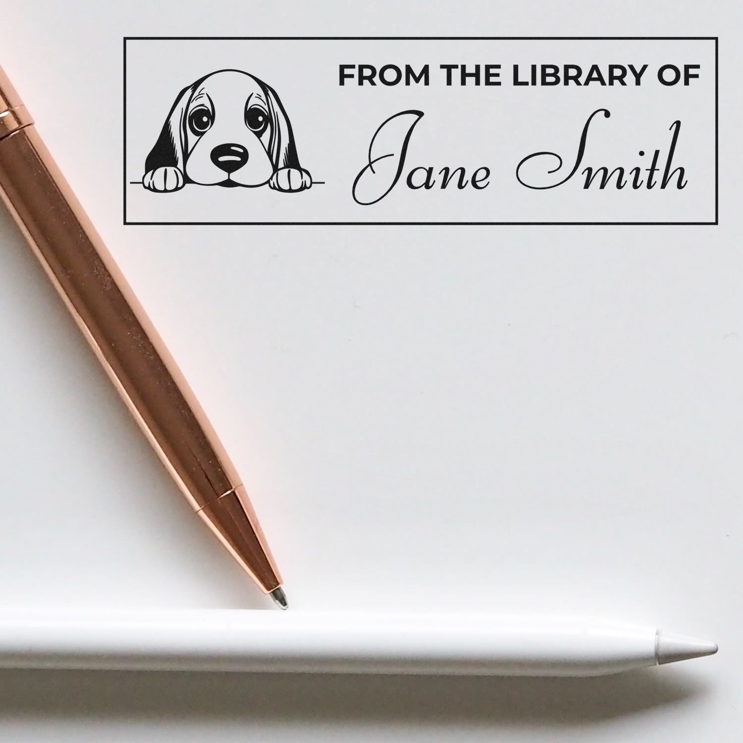 Personalized rubber library stamp with dog illustration, From the Library of Jane Smith, for custom book ownership labeling.