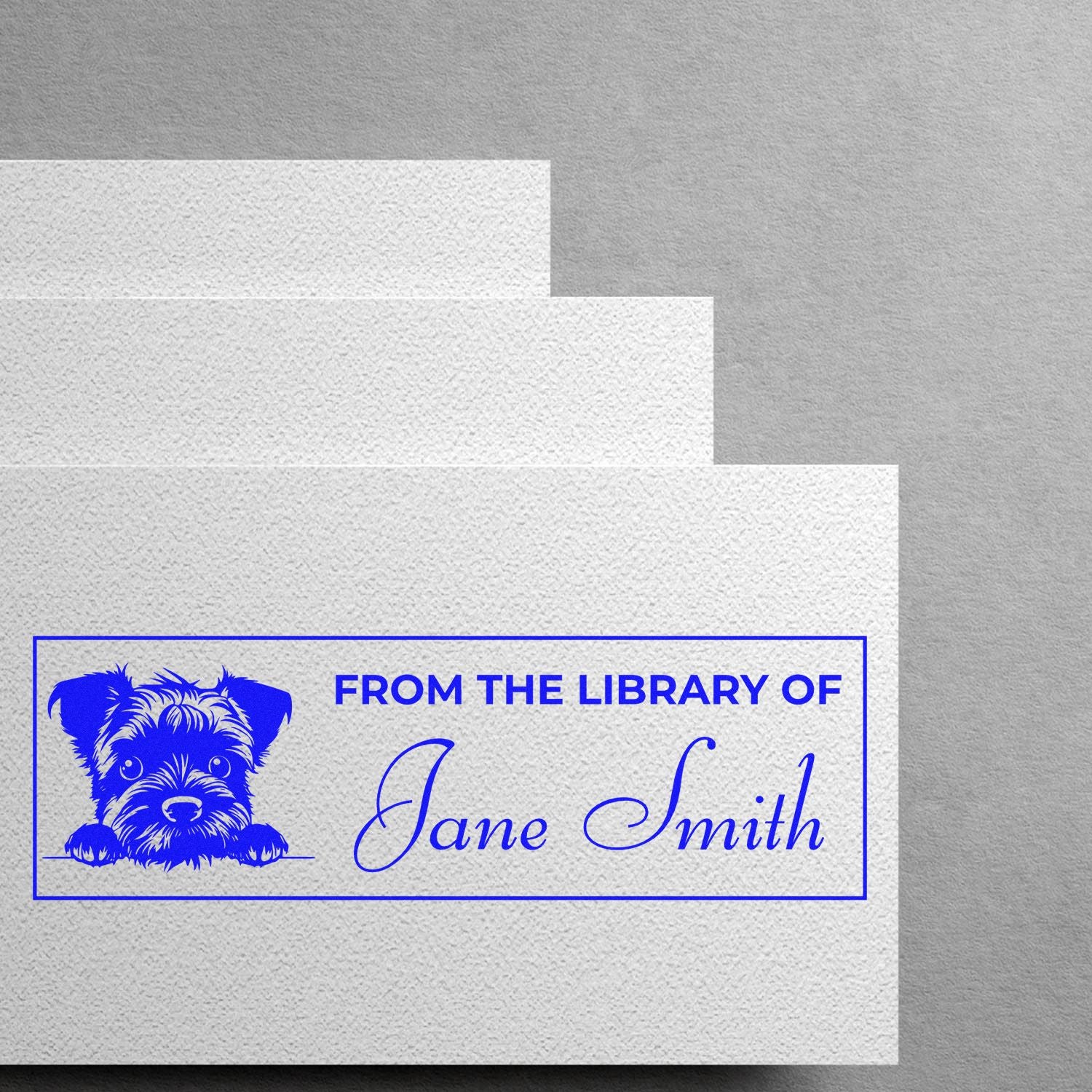 Personalized rubber stamp for books reading From the Library of Jane Smith with puppy graphic for custom book labeling.