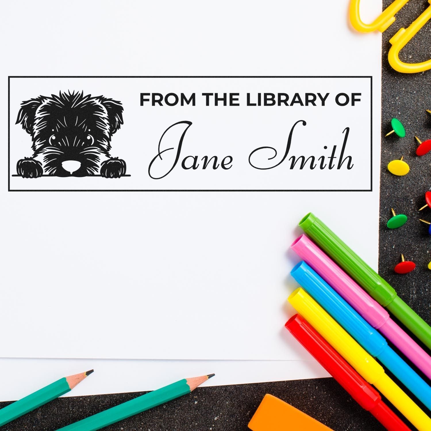 Custom library rubber stamp with dog design and personalized name for marking books as "From the Library of Jane Smith."