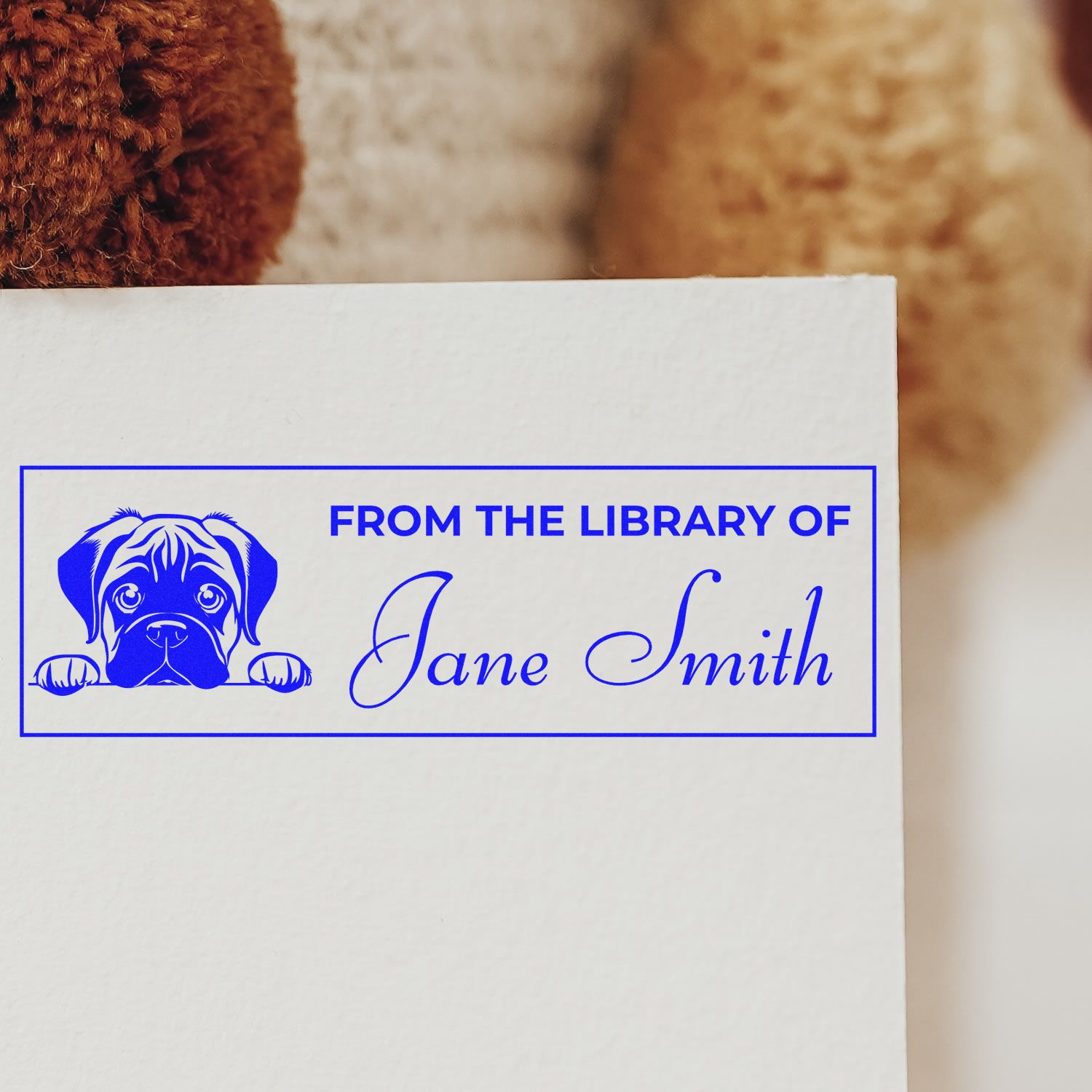 Personalized rubber book stamp with dog artwork and From the Library of Jane Smith library ownership imprint.