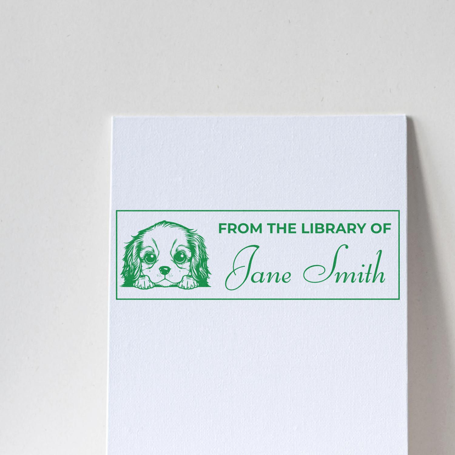 Custom rubber stamp with dog illustration and From the Library of Jane Smith for personalized bookplate ownership marking.