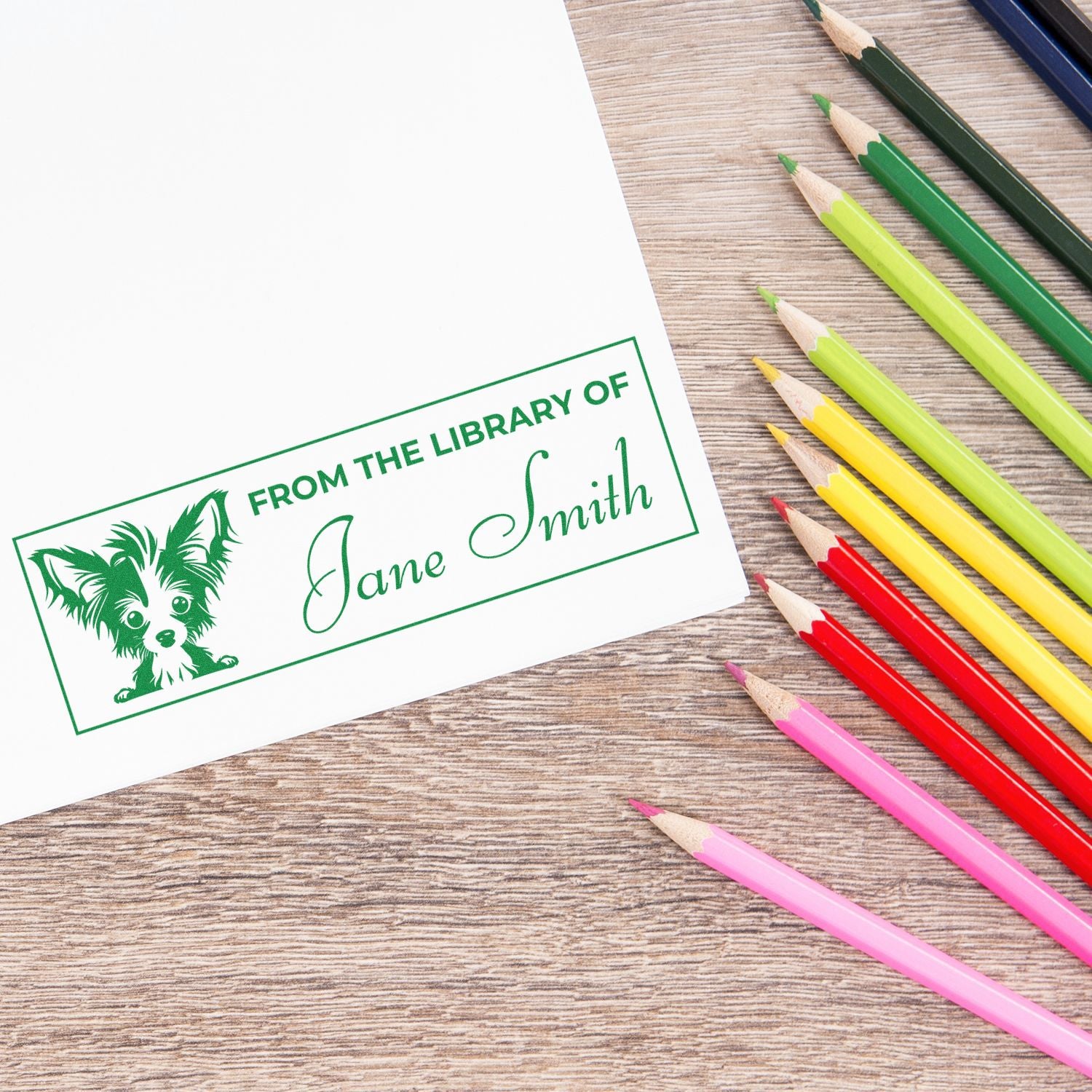 Custom personalized library rubber stamp reading From the Library of Jane Smith for marking book ownership.