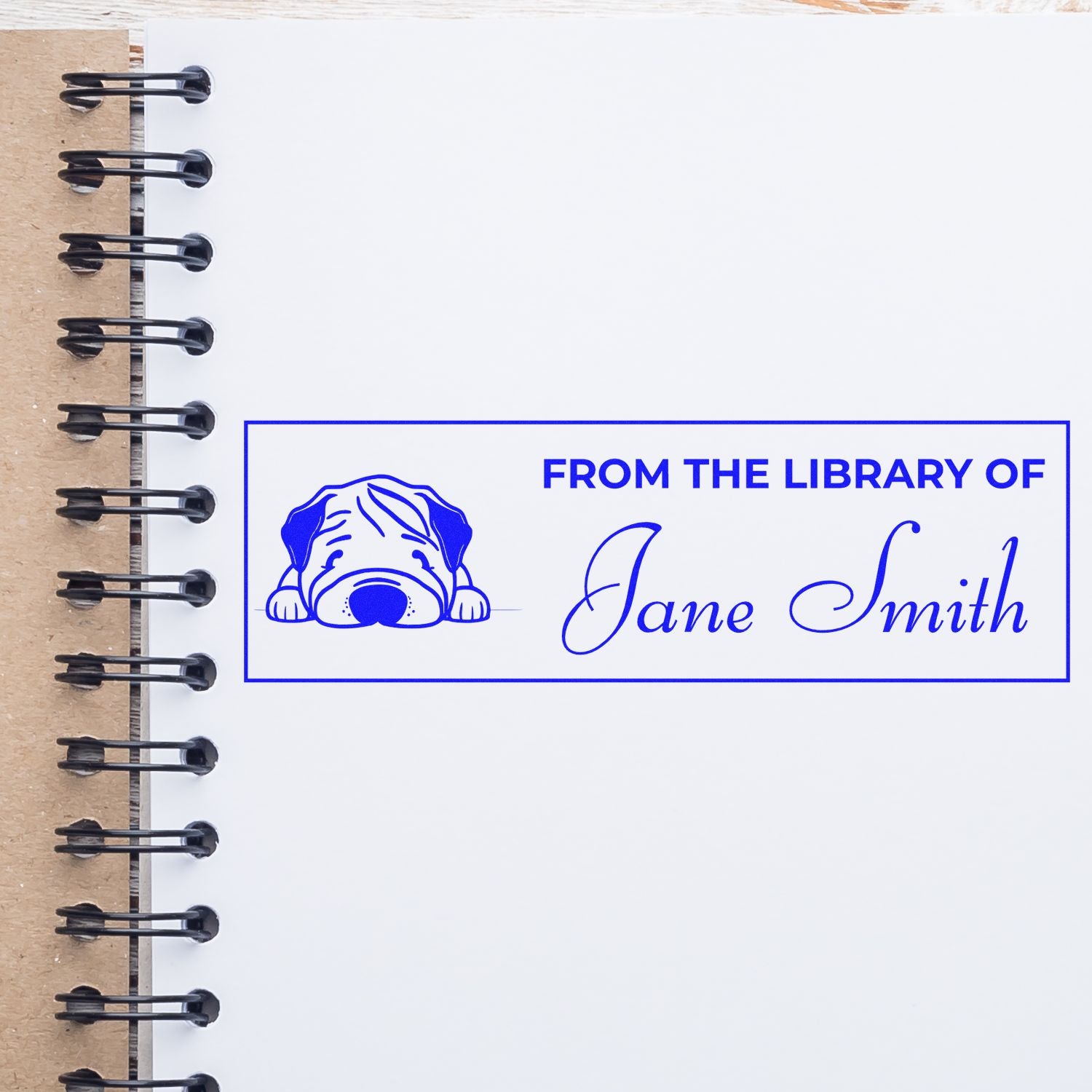 Custom library rubber stamp with dog design and personalized name for marking books From the Library Of Jane Smith.