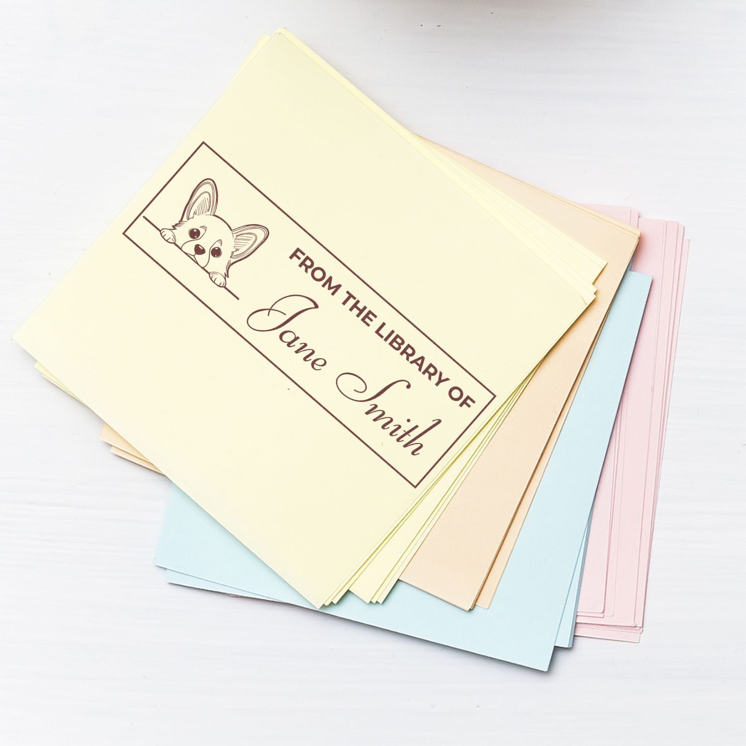 Custom rubber stamp bookplate reading From the Library of Jane Smith on pastel paper, ideal for personal book labeling.