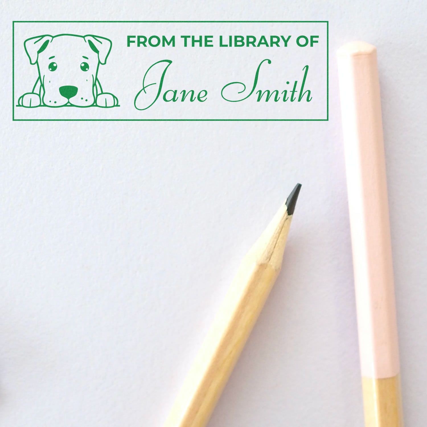 Custom rubber stamp reading From the Library of Jane Smith with puppy illustration for personal library book labeling.