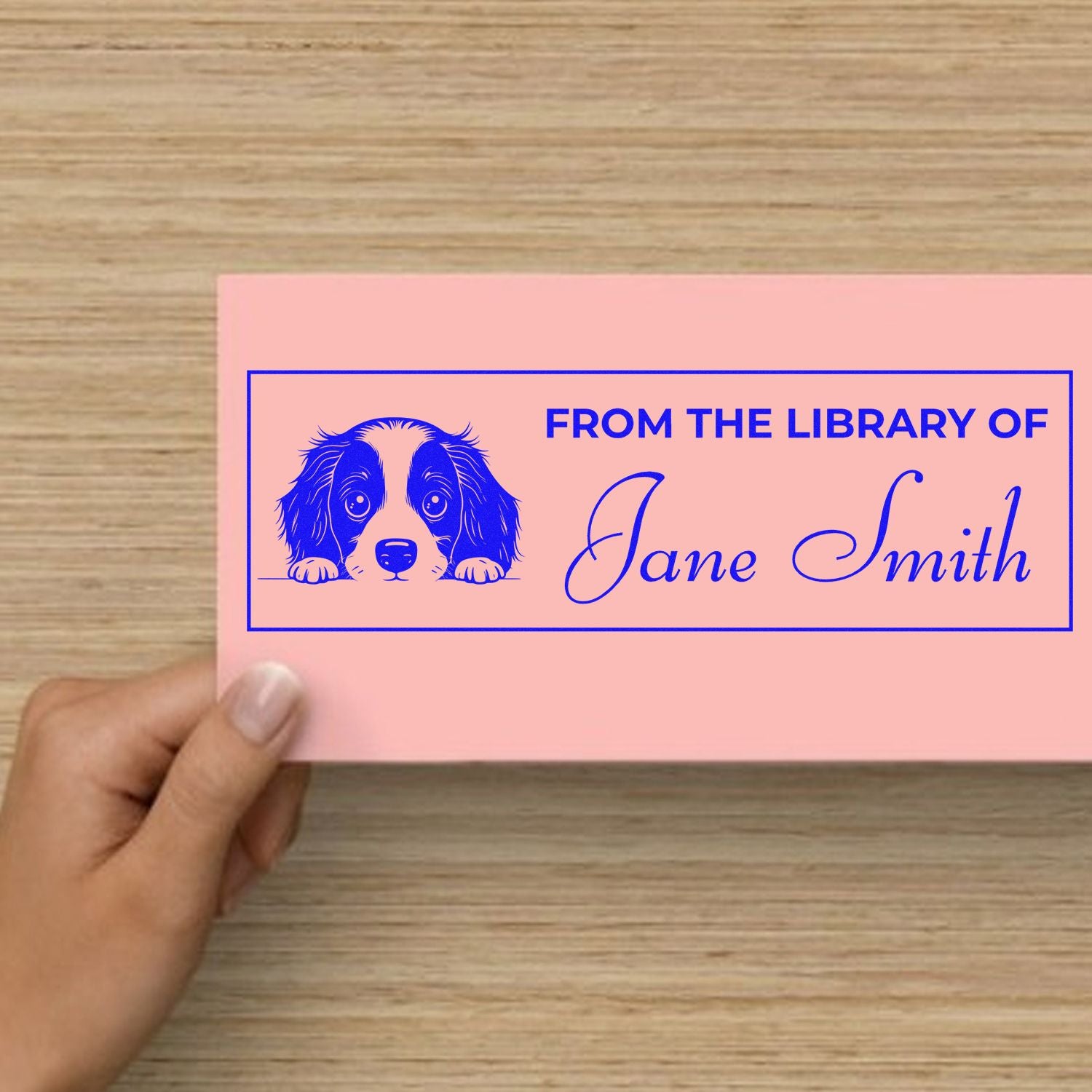 Personalized rubber library stamp with dog illustration and From the Library of Jane Smith custom ex libris design.