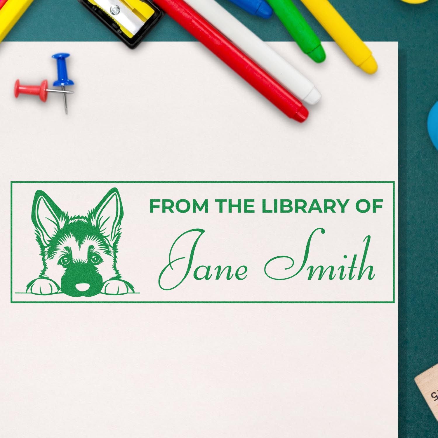 Personalized rubber library stamp with dog graphic and From the Library of Jane Smith text for book labeling.